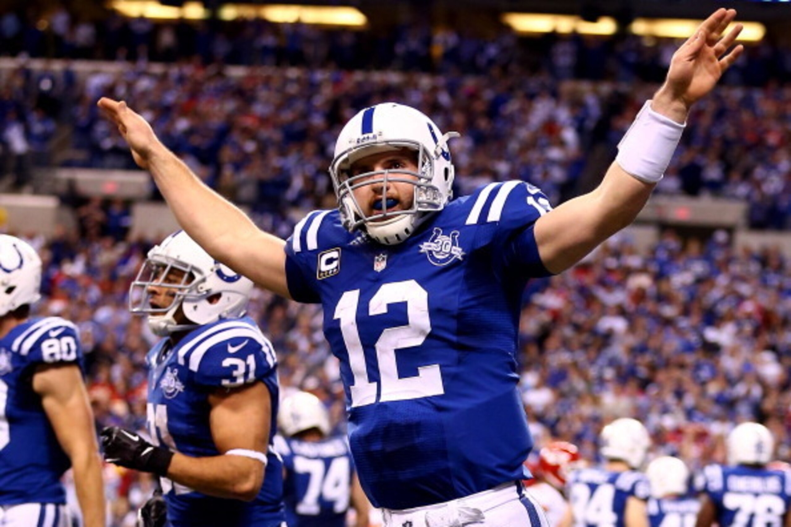 INDIANAPOLIS, IN - JANUARY 04:  Quarterback Andrew Luck #12 of the Indianapolis Colts celebrates a fourth quarter touchdown against the Kansas City Chiefs during a Wild Card Playoff game at Lucas Oil Stadium on January 4, 2014 in Indianapolis, Indiana.  (