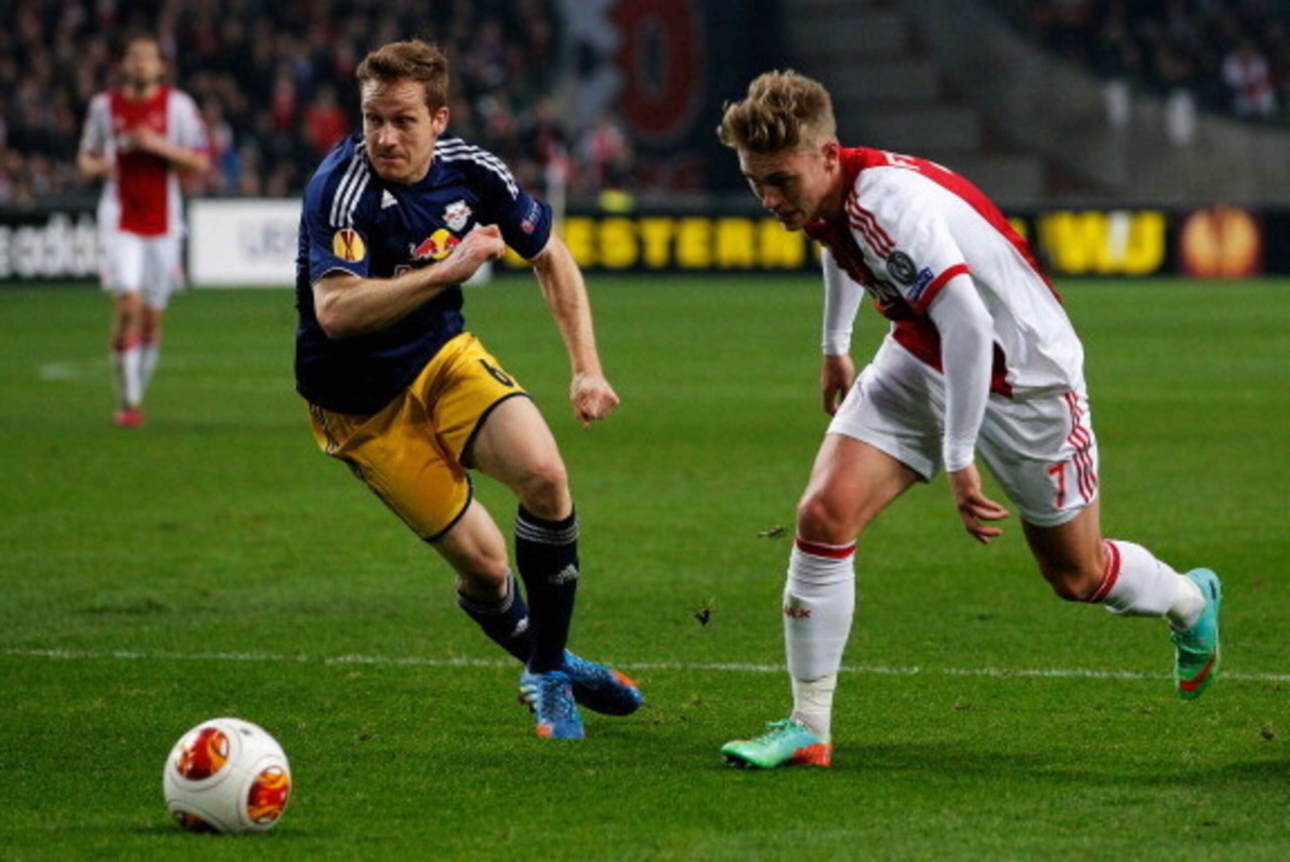 AMSTERDAM, NETHERLANDS - FEBRUARY 20:  Viktor Fischer of Ajax and Christian Schwegler of Salzburg battle for the ball during the UEFA Europa League Round of 32 match between Ajax Amsterdam and FC Salzburg at Amsterdam Arena on February 20, 2014 in Amsterd