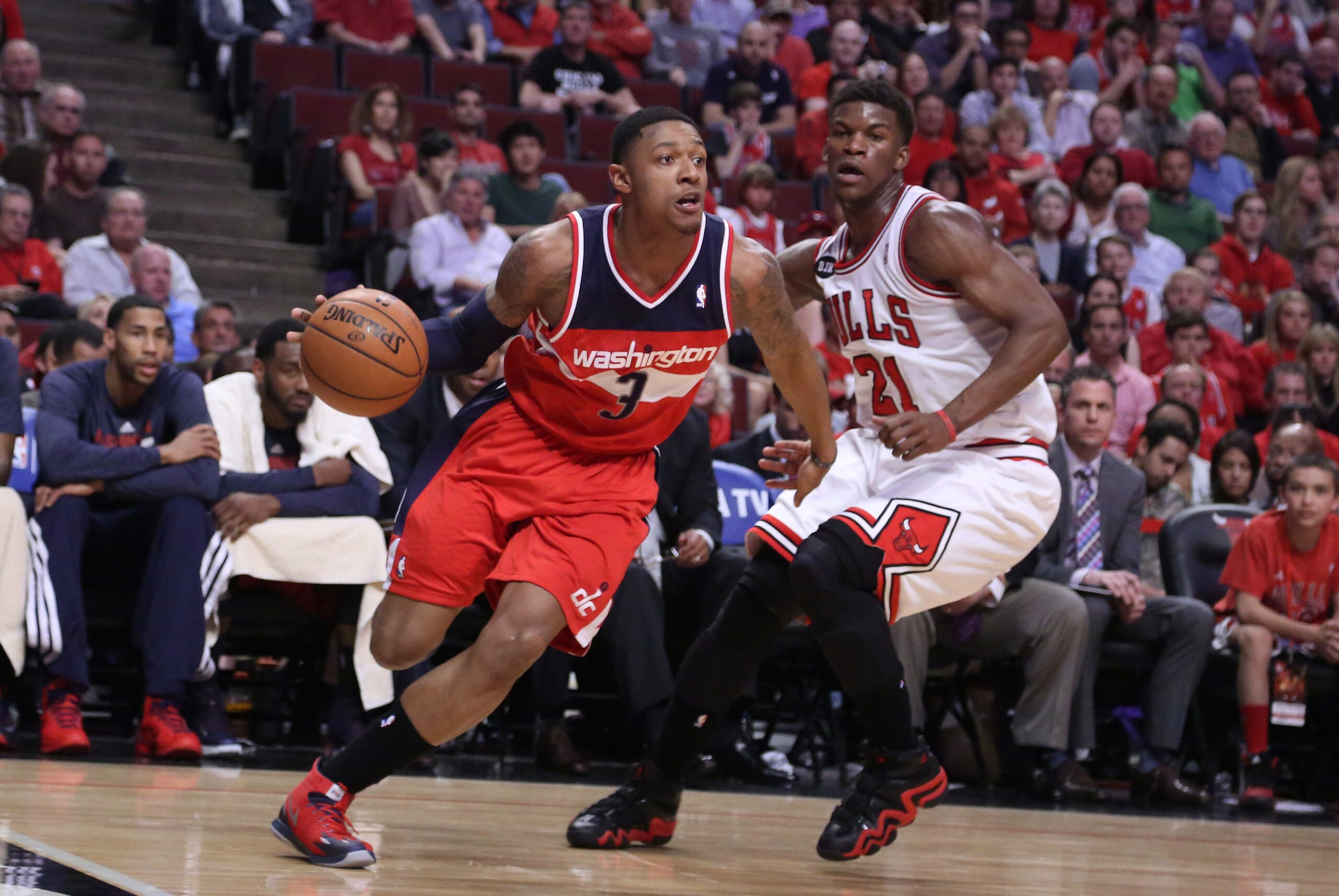 Apr 20, 2014; Chicago, IL, USA; Washington Wizards guard Bradley Beal (3) drives around Chicago Bulls guard Jimmy Butler (21) during the second quarter of game one of the first round of the 2014 NBA Playoffs at the United Center. Mandatory Credit: Dennis