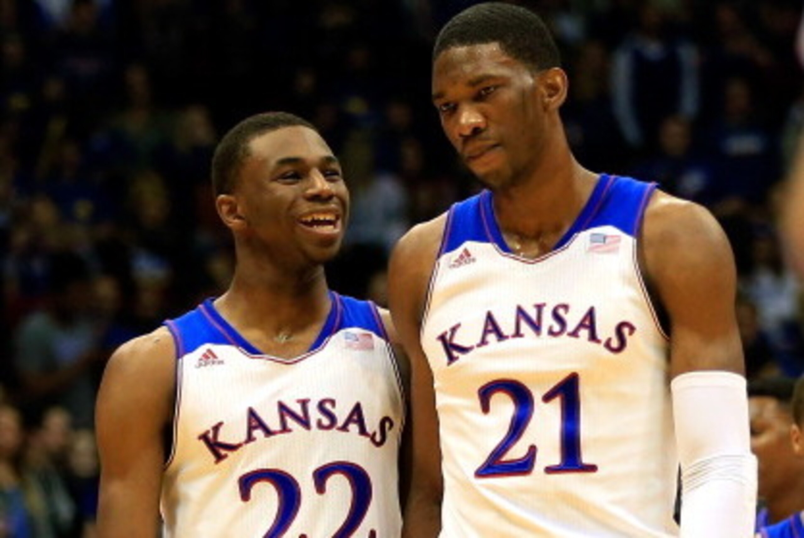 LAWRENCE, KS - NOVEMBER 22: Andrew Wiggins #22 of the Kansas Jayhawks talks with Joel Embiid #21 as they walk onto the floor after a timeout during the game against the Towson Tigers at Allen Fieldhouse on November 22, 2013 in Lawrence, Kansas. (Photo by