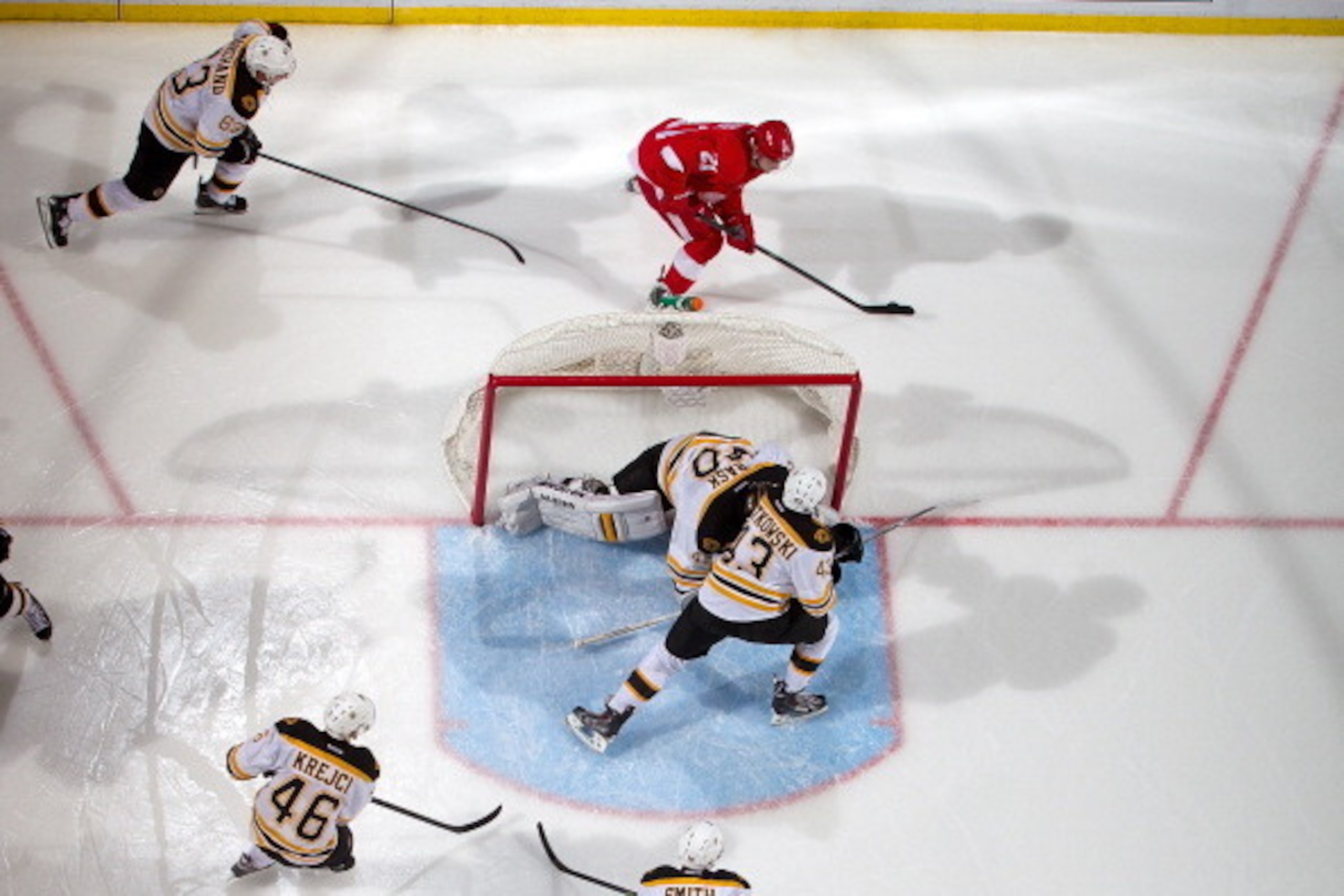 DETROIT, MI - APRIL 22:  Tomas Tatar #21 of the Detroit Red Wings skates with the puck as goalie Tuukka Rask #40 of the Boston Bruins covers the net and teammates Brad Marchand #63, Matt Bartkowski #43, David Krejci #46 and Reilly Smith #18 all close in o