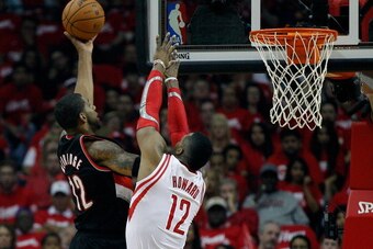 HOUSTON, TX - APRIL 20:  LaMarcus Aldridge #12 of the Portland Trail Blazers drives against Dwight Howard #12 of the Houston Rockets in Game One of the Western Conference Quarterfinals during the 2014 NBA Playoffs at the Toyota Center on April 20, 2014 in