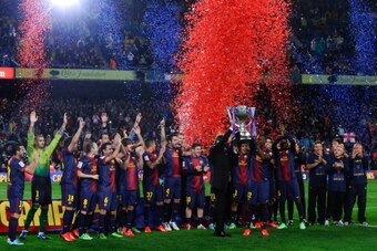 BARCELONA, SPAIN - MAY 19:  Head coach Tito Vilanova and Eric Abidal of FC Barcelona holds up the trophy during the celebration after winning the Spanish League after the La Liga match between FC Barcelona and Real Valladolid CF at Camp Nou on May 19, 201