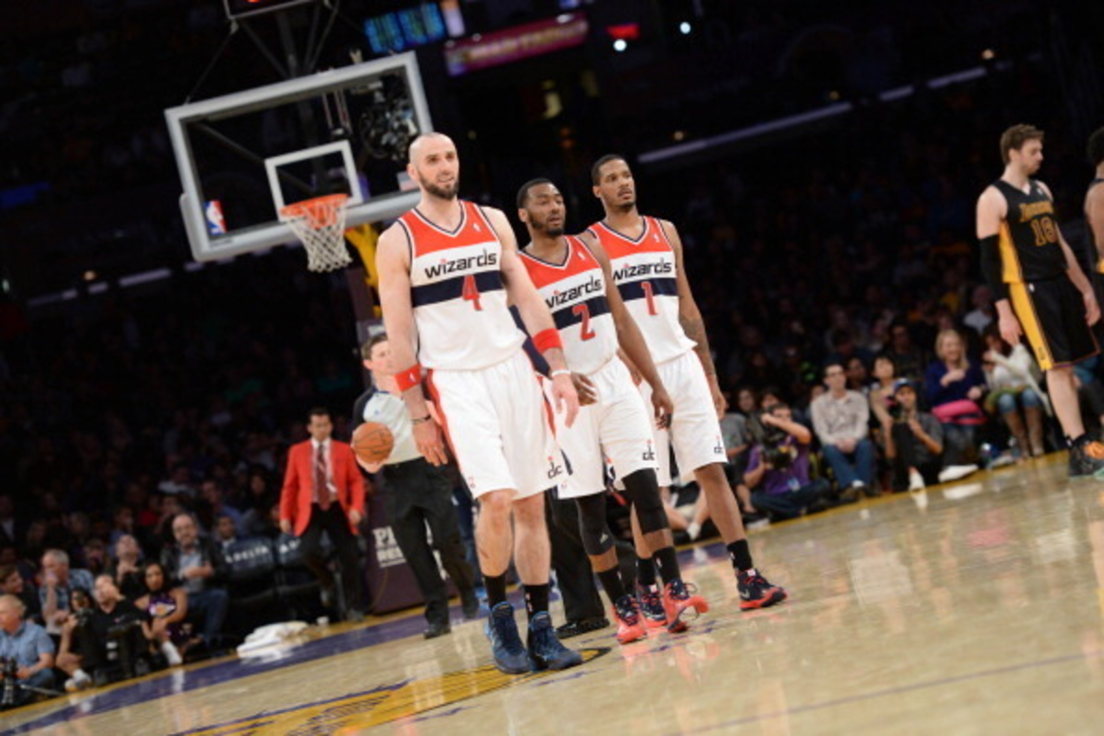 LOS ANGELES, CA - MARCH 21: Marcin Gortat #4, John Wall #2, and Trevor Ariza #1 of the Washington Wizards walk toward their bench in a game against the Los Angeles Lakers at Staples Center on March 21, 2014 in Los Angeles, California. NOTE TO USER: User e