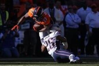 Jan 19, 2014; Denver, CO, USA; Denver Broncos running back Knowshon Moreno (27) is tackled by New England Patriots cornerback Logan Ryan (26) during the 2013 AFC Championship football game at Sports Authority Field at Mile High. Mandatory Credit: Mark J. 