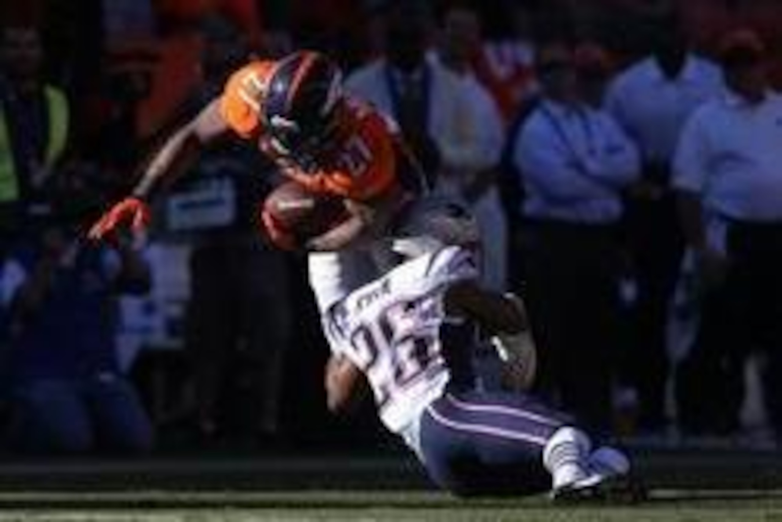 Jan 19, 2014; Denver, CO, USA; Denver Broncos running back Knowshon Moreno (27) is tackled by New England Patriots cornerback Logan Ryan (26) during the 2013 AFC Championship football game at Sports Authority Field at Mile High. Mandatory Credit: Mark J. 