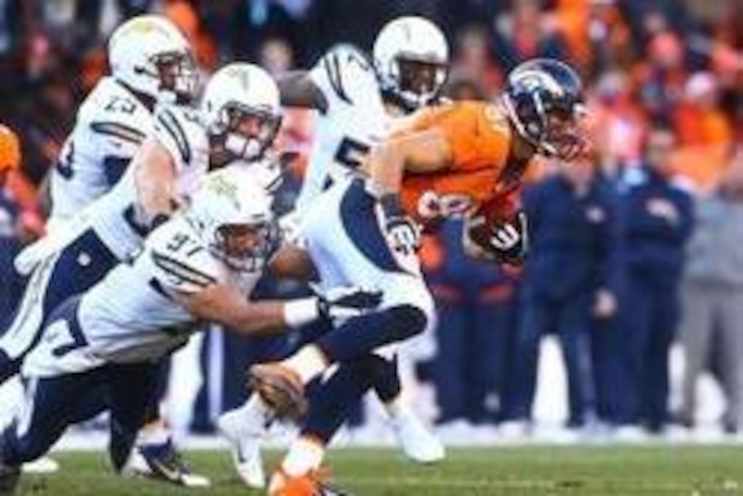 Jan 12, 2014; Denver, CO, USA; Denver Broncos wide receiver Eric Decker returns a kickoff under pressure from San Diego Chargers linebacker Bront Bird in the second quarter during the 2013 AFC divisional playoff football game at Sports Authority Field at