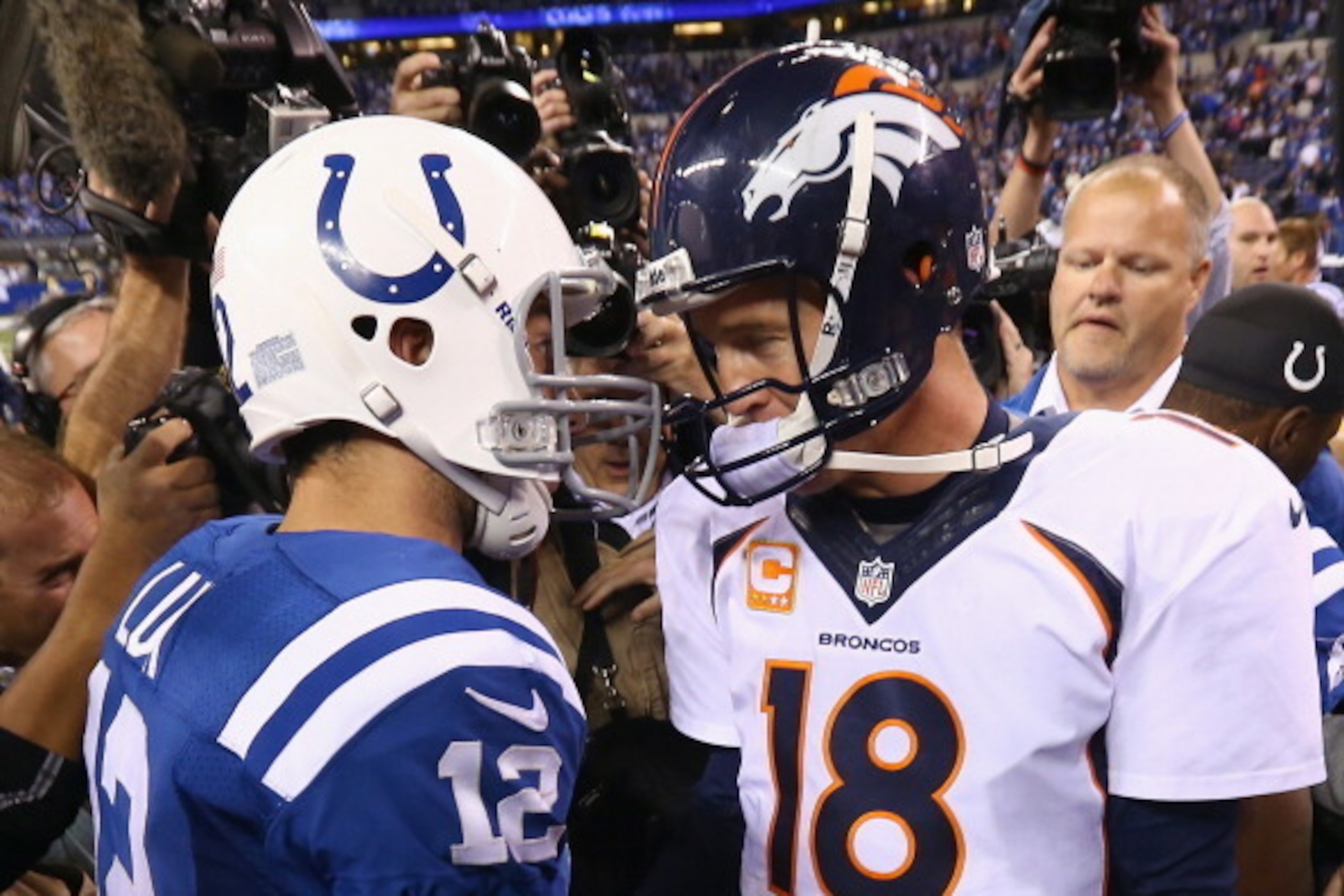 INDIANAPOLIS, IN - OCTOBER 20:  Andrew Luck #12 of the Indianapolis Colts and Peyton Manning #18 of the Denver Broncos meet after the game at Lucas Oil Stadium on October 20, 2013 in Indianapolis, Indiana. The Colts won 39-33.  (Photo by Andy Lyons/Getty 