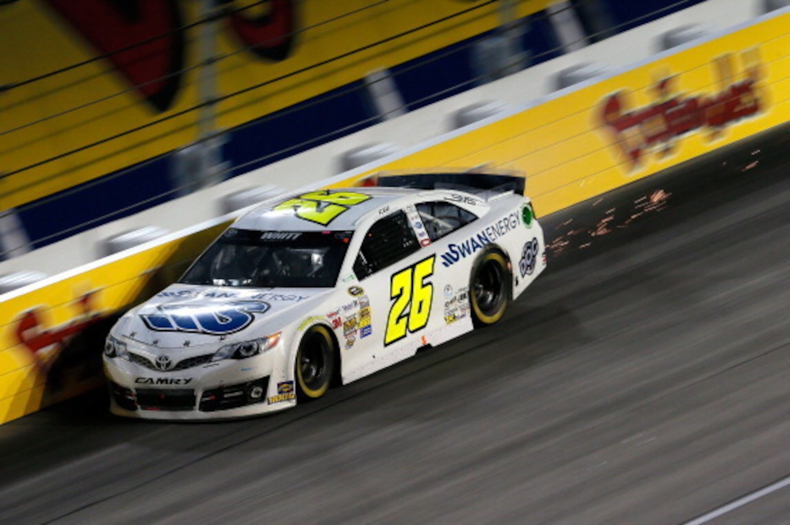 DARLINGTON, SC - APRIL 12:  Sparks are seen coming from the #26 Swan Energy Toyota, driven by Cole Whitt, during the NASCAR Sprint Cup Series Bojangles' Southern 500 at Darlington Raceway on April 12, 2014 in Darlington, South Carolina.  (Photo by Kevin C