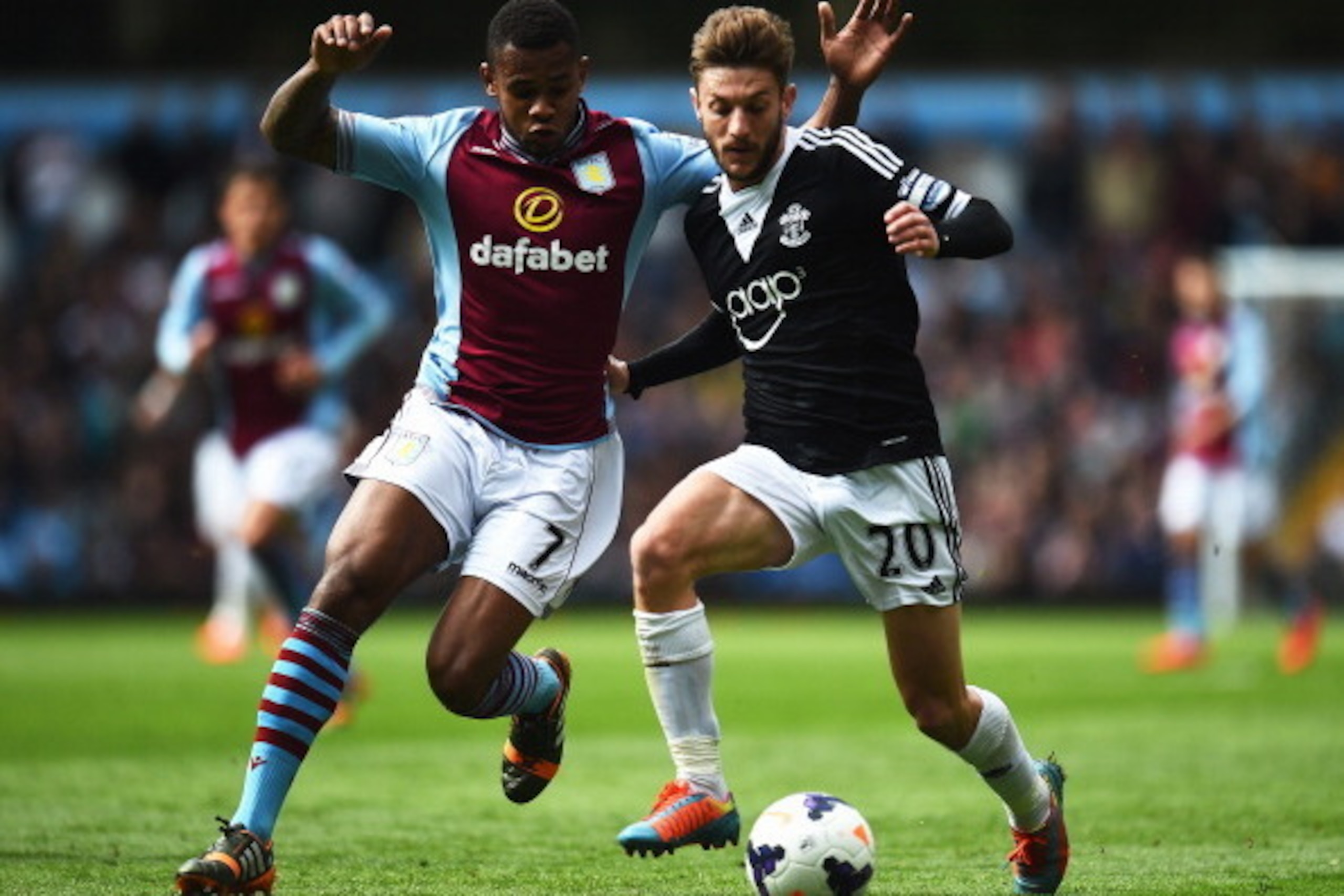 BIRMINGHAM, ENGLAND - APRIL 19:  (L-R) Leandro Bacuna of Aston Villa and Adam Lallana of Southampton challenge for the ball during the Barclays Premier League match between Aston Villa and Southampton at Villa Park on April 19, 2014 in Birmingham, England