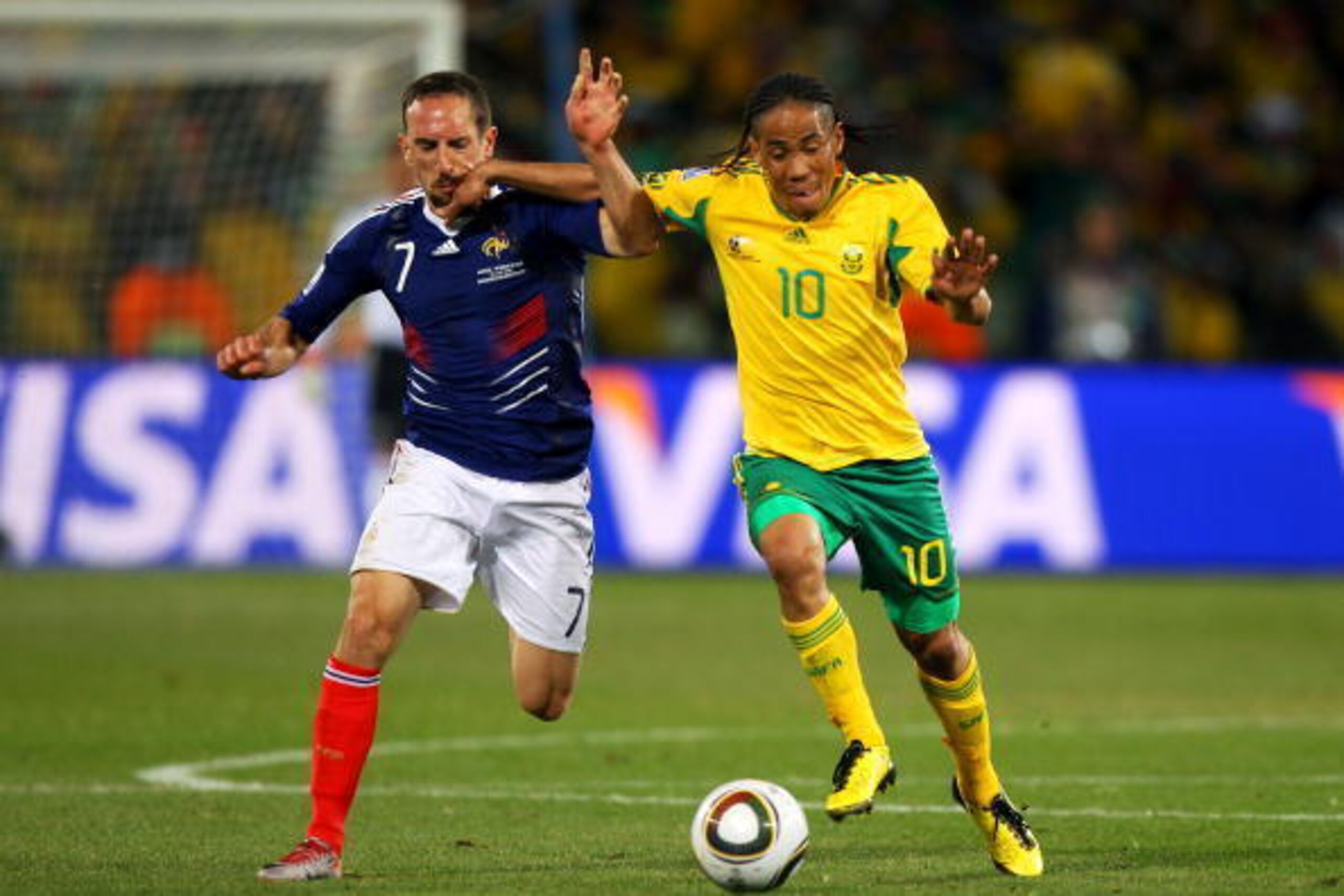 BLOEMFONTEIN, SOUTH AFRICA - JUNE 22:  Steven Pienaar of South Africa fends off a challenge by Franck Ribery of France during the 2010 FIFA World Cup South Africa Group A match between France and South Africa at the Free State Stadium on June 22, 2010 in