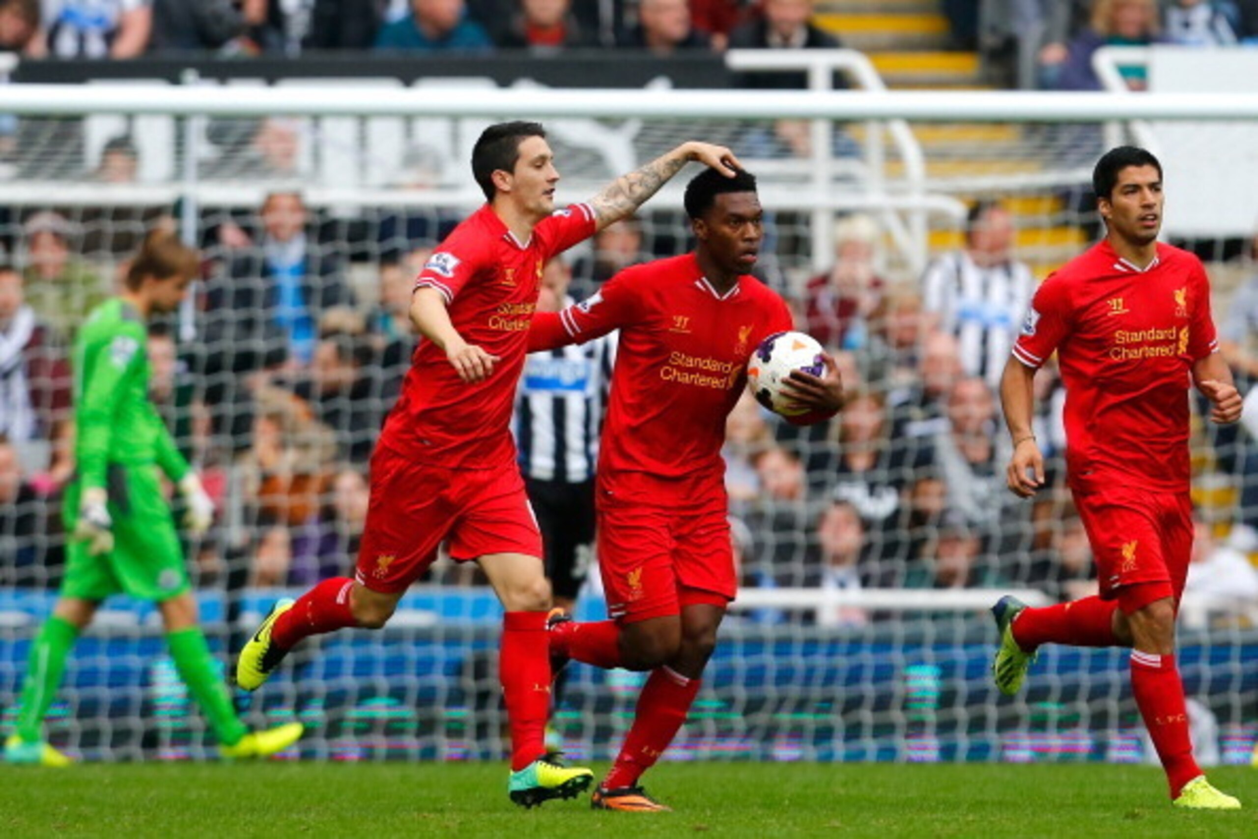 NEWCASTLE-UPON-TYNE, ENGLAND - OCTOBER 19: Daniel Sturridge (C) of Liverpool celebrates scoring his team's second goal with team-mate Luis Alberto during the Barclays Premier League match between Newcastle United and Liverpool at St James' Park on October