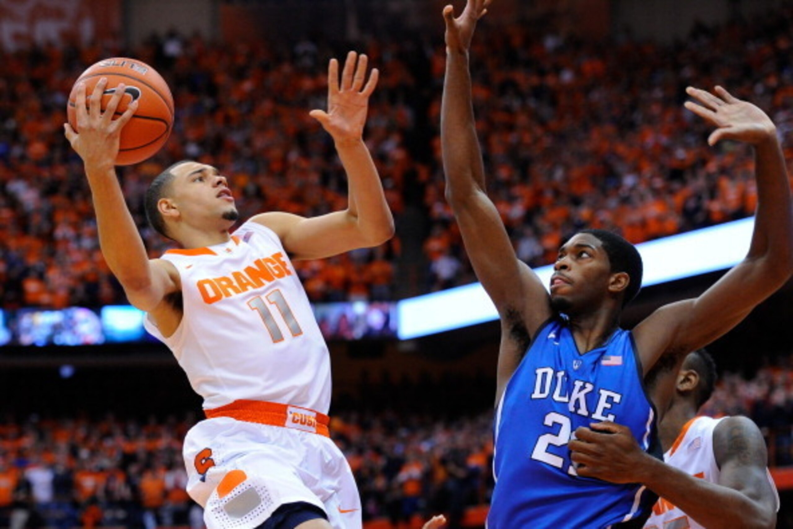 SYRACUSE, NY - FEBRUARY 01:  Tyler Ennis #11 of the Syracuse Orange takes a shot against the defense of Amile Jefferson #21 of the Duke Blue Devils during the first half at the Carrier Dome on February 1, 2014 in Syracuse, New York.  (Photo by Rich Barnes