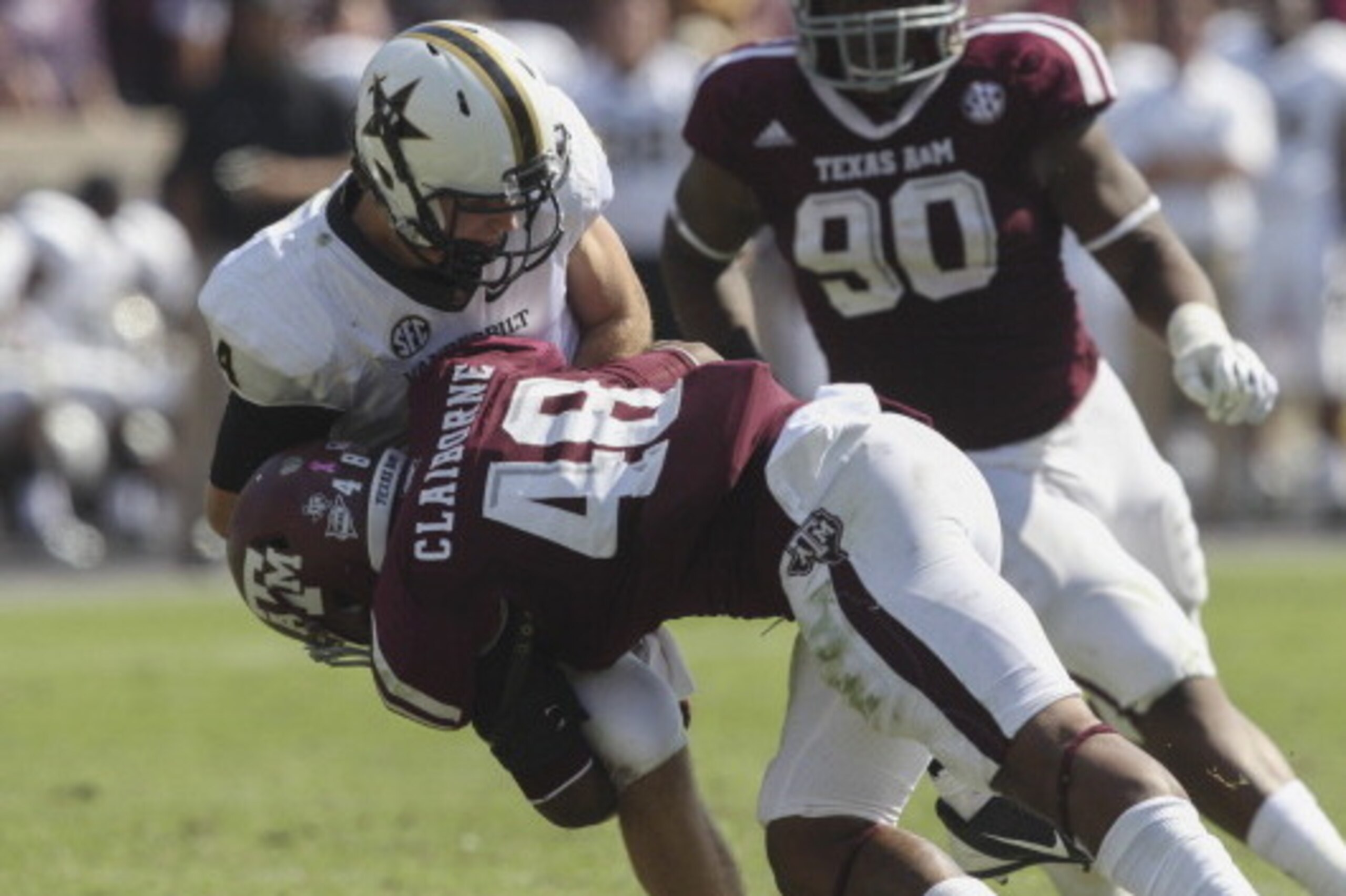 COLLEGE STATION, TX - OCTOBER 26:  Darian Claiborne #48 of the Texas A&M Aggies lays a hard hit on Patton Robinette #4 of the Vanderbilt Commodores at Kyle Field on October 26, 2013 in College Station, Texas.  (Photo by Bob Levey/Getty Images)