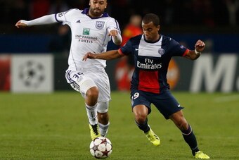 PARIS, FRANCE - NOVEMBER 05:  Lucas of PSG is tackled by Anthony Vanden Borre of Anderlecht during the UEFA Champions League Group C match between Paris Saint Germain and RSC Anderlecht at Parc des Princes on November 5, 2013 in Paris, France.  (Photo by