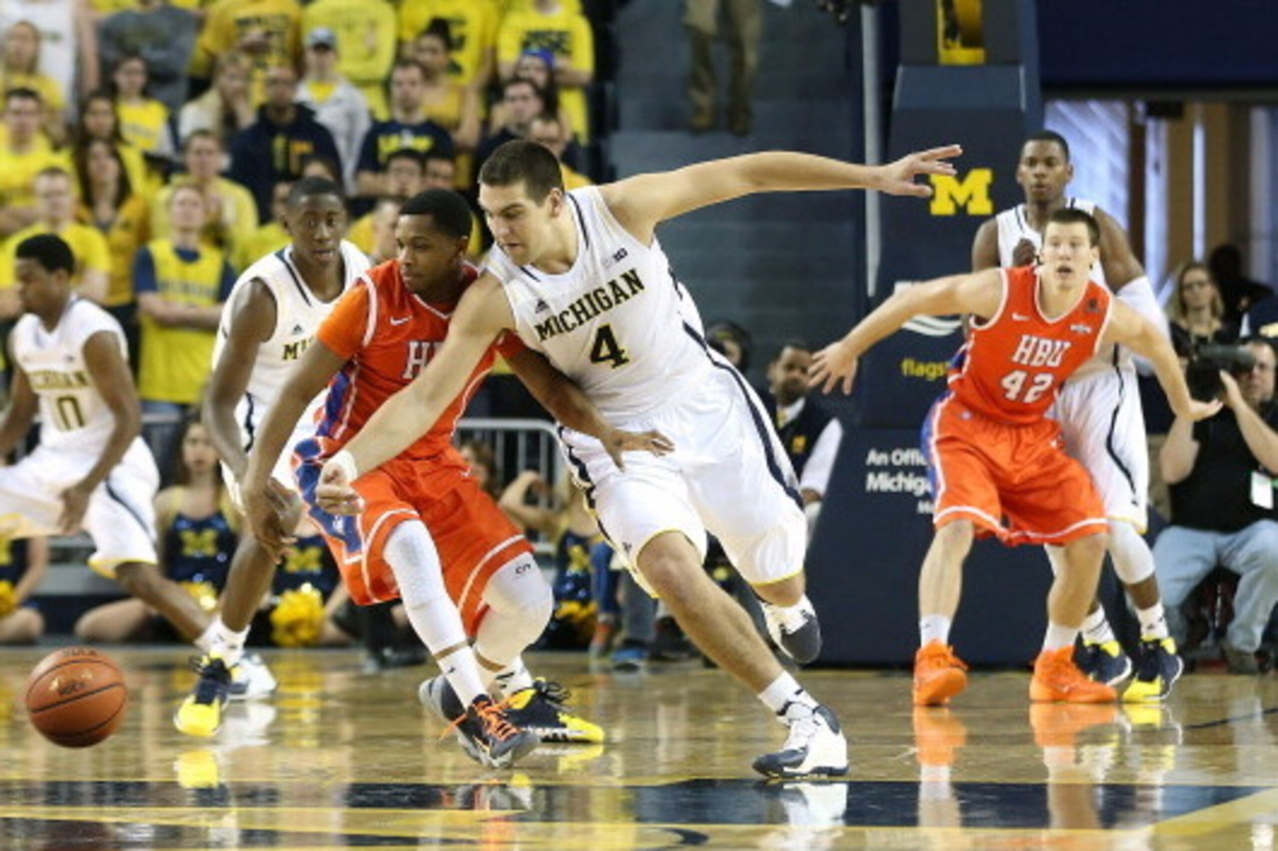 ANN ARBOR, MI - DECEMBER 07:  Mitch McGary #4 of the University of Michigan Wolverines drives the ball up the court during the second half of the game against Houston Baptist Huskies at the Crisler Center on December 7, 2013 in Ann Arbor, Michigan. Michig