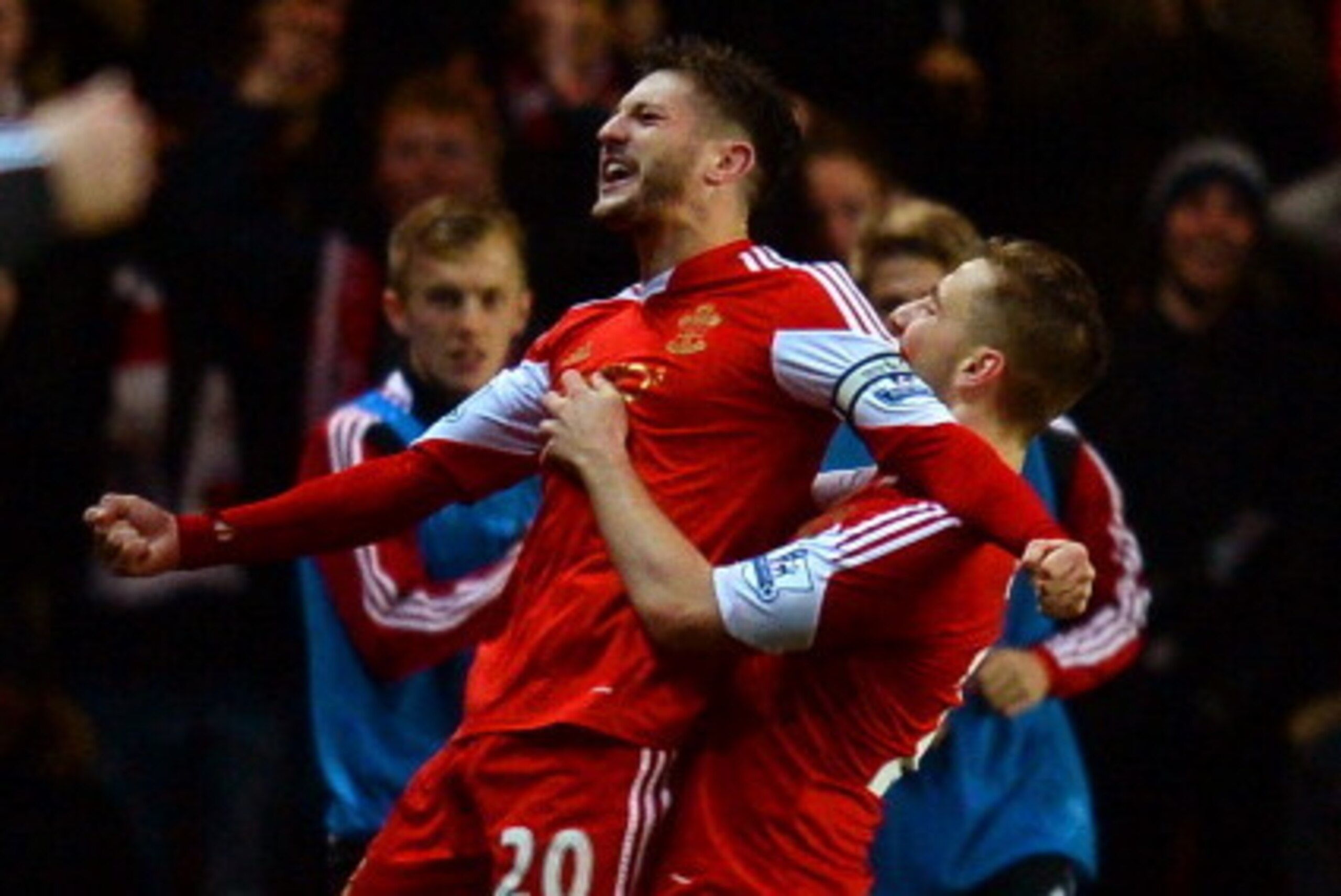 SOUTHAMPTON, ENGLAND - JANUARY 28:  Adam Lallana of Southampton celebrates scoring their second goal with Luke Shaw of Southampton during the Barclays Premier League match between Southampton and Arsenal at St Mary's Stadium on January 28, 2014 in Southam