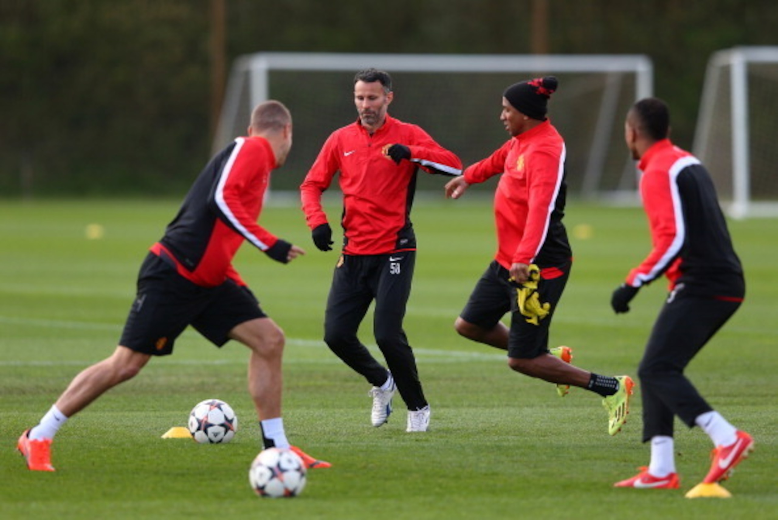 MANCHESTER, ENGLAND - APRIL 08:  Ashley Young of Manchester United challenges Ryan Giggs during a training session at Aon Training Complex on April 8, 2014 in Manchester, England.  (Photo by Alex Livesey/Getty Images)