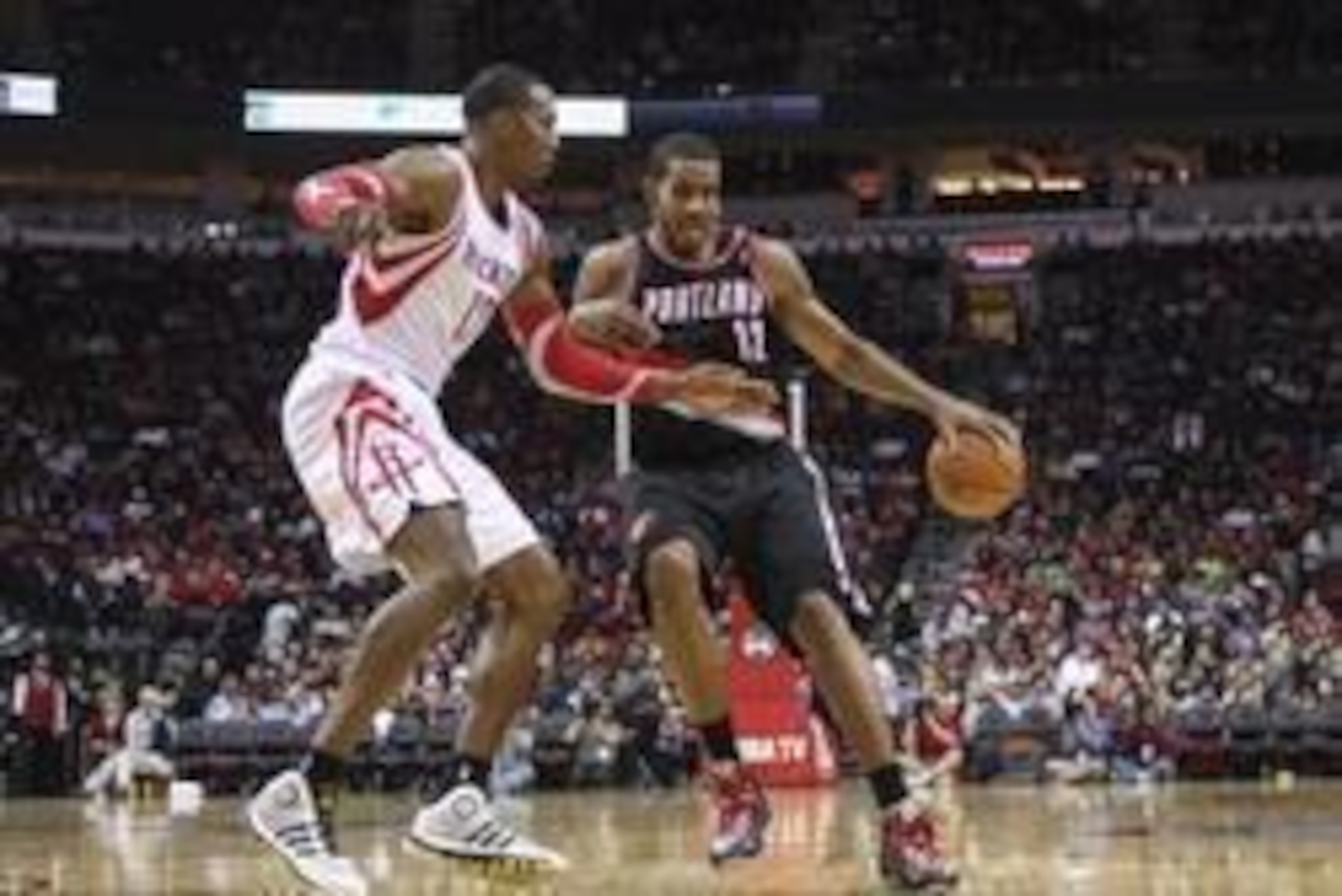 Jan 20, 2014; Houston, TX, USA; Portland Trail Blazers power forward LaMarcus Aldridge (12) controls the ball during the third quarter as Houston Rockets center Dwight Howard (12) defends at Toyota Center. The Rockets defeated the Trailblazers 126-113. Ma