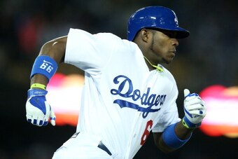 LOS ANGELES, CA - APRIL 23:  Yasiel Puig #66 of the Los Angeles Dodgers runs to first on his way to an RBI triple in the seventh inning against the Philadelphia Phillies at Dodger Stadium on April 23, 2014 in Los Angeles, California.  (Photo by Stephen Du