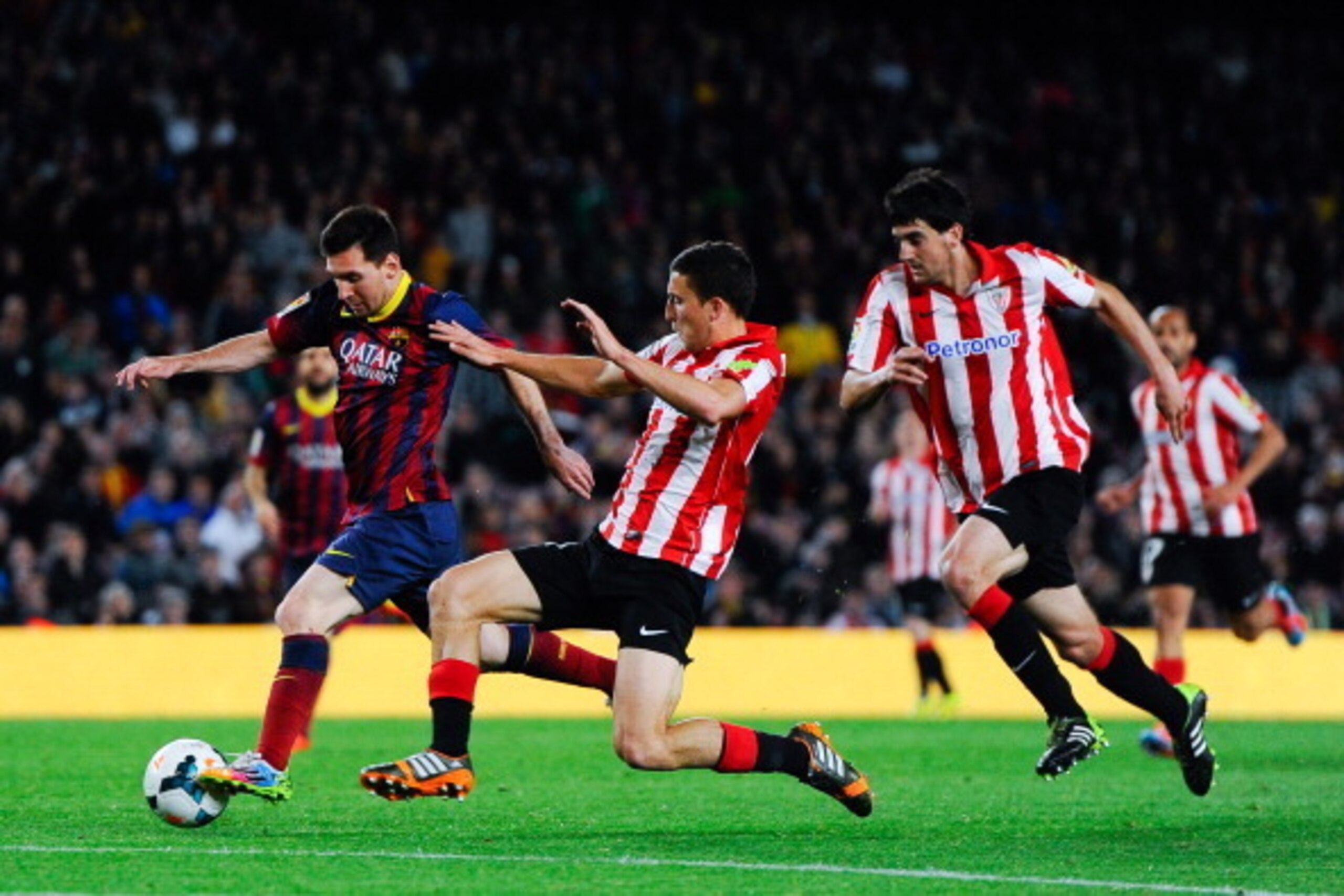 BARCELONA, SPAIN - APRIL 20: Lionel Messi of FC Barcelona competes for the ball with Oscar de Marcos of Athletic Club during the La Liga match between FC Barcelona and Athletic Club at Camp Nou on April 20, 2014 in Barcelona, Spain.  (Photo by David Ramos
