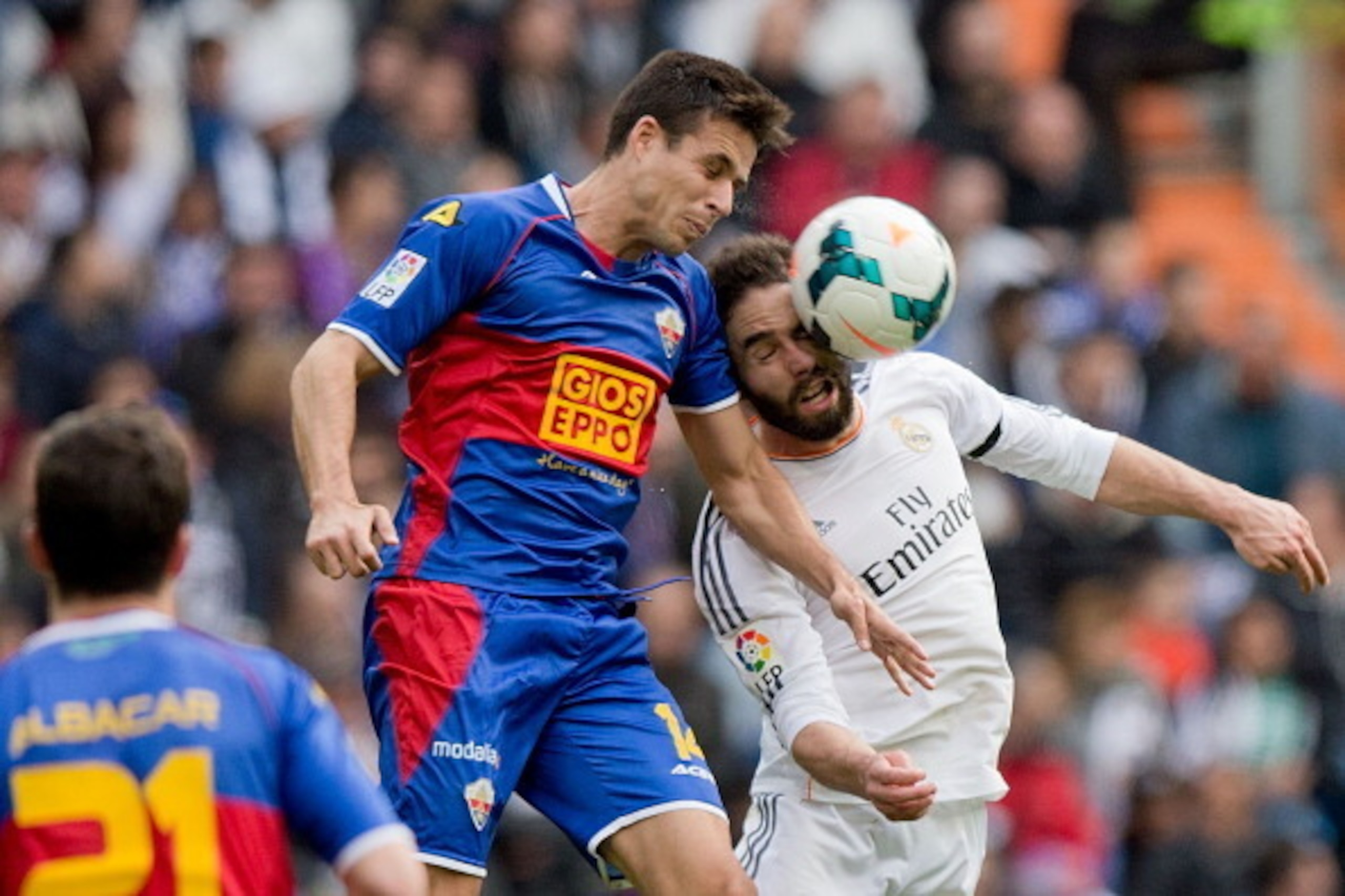 MADRID, SPAIN - FEBRUARY 22: Daniel Carvajal (R) of Real Madrid CF wins the header before Manu del Moral of  Elche FC during the La Liga match between Real Madrid CF and Elche CF at Estadio Santiago Bernabeu on February 22, 2014 in Madrid, Spain.  (Photo 