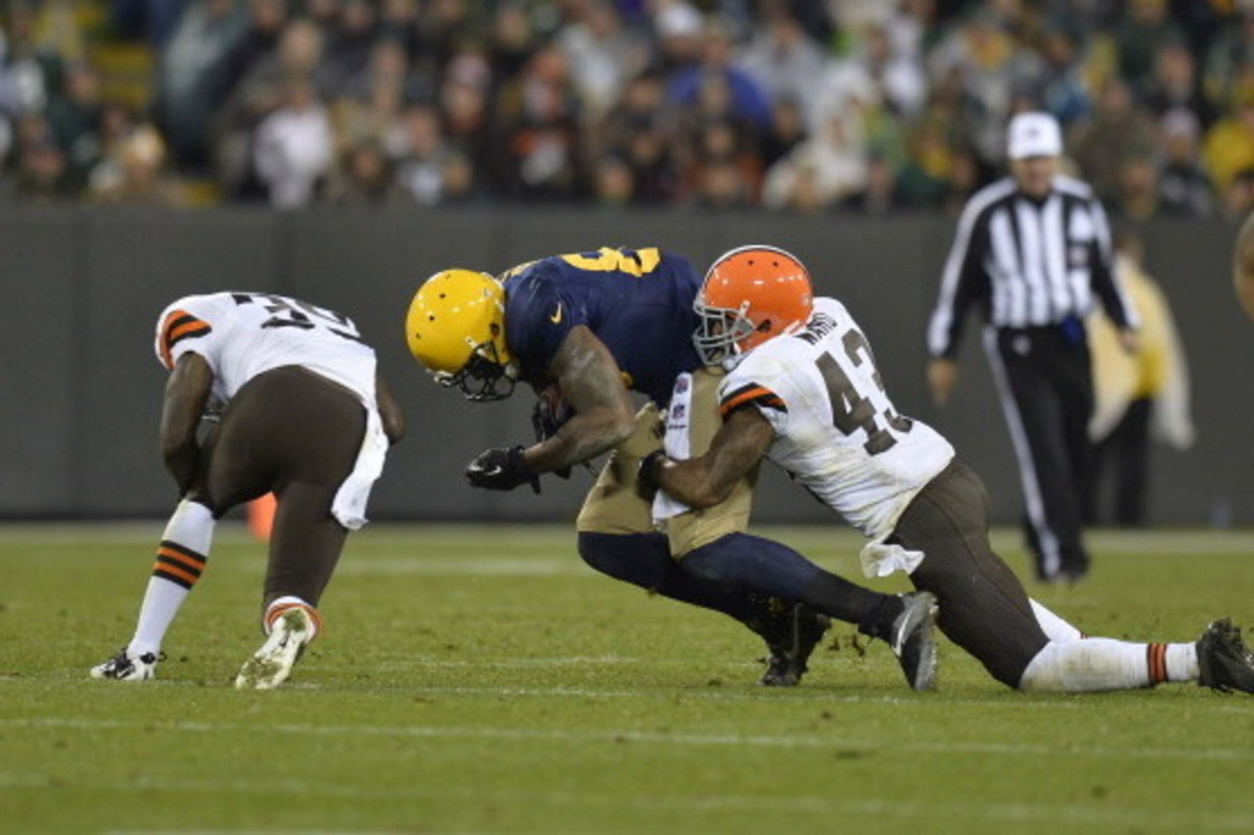 GREEN BAY, WI - OCTOBER 20:  Defensive backs Tashaun Gipson #39 (L) and T.J. Ward #43 (R) of the Cleveland Browns tackle tight end Jermichael Finley #88 of the Green Bay Packers after a 10-yard reception during the fourth quarter at Lambeau Field on Octob