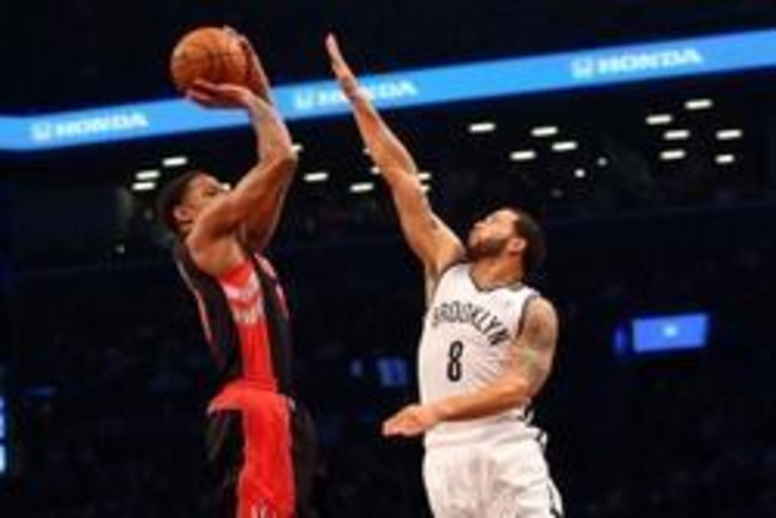 Apr 25, 2014; Brooklyn, NY, USA; Toronto Raptors guard DeMar DeRozan (10) shoots over Brooklyn Nets guard Deron Williams (8) during the first quarter in game three of the first round of the 2014 NBA Playoffs at Barclays Center. Mandatory Credit: Anthony G