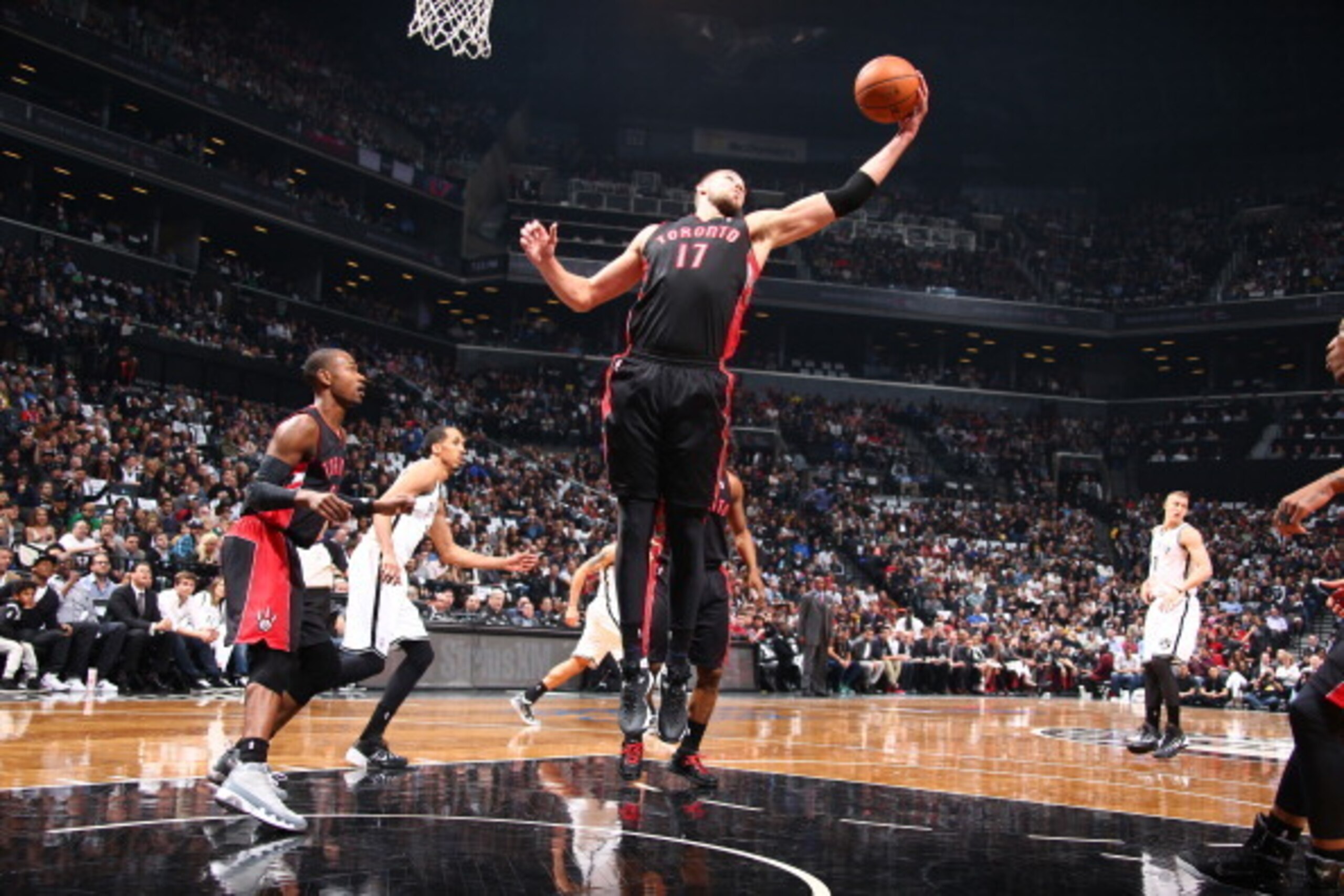 BROOKLYN, NY - APRIL 25: Jonas Valanciunas #17 of the Toronto Raptors rebounds against the Brooklyn Nets in Game Three of the Eastern Conference Quarterfinals during the NBA Playoffs on April 25, 2014 at the Barclays Center in Brooklyn, New York. NOTE TO 
