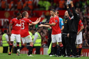 MANCHESTER, ENGLAND - AUGUST 22:  Ryan Giggs of Manchester United comes on for team mate Tom Cleverley during the Barclays Premier League match between Manchester United and Tottenham Hotspur at Old Trafford on August 22, 2011 in Manchester, England.  (Ph