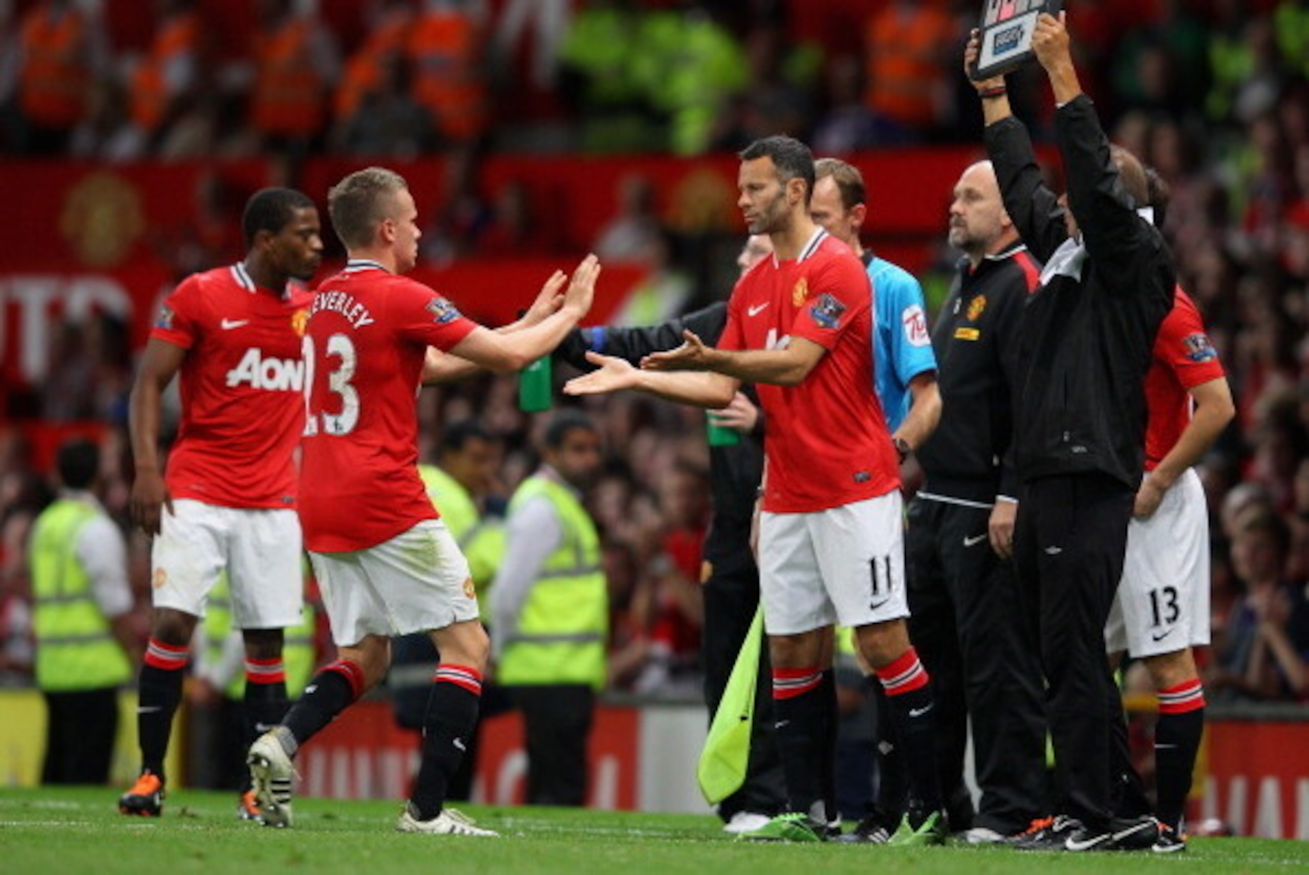 MANCHESTER, ENGLAND - AUGUST 22:  Ryan Giggs of Manchester United comes on for team mate Tom Cleverley during the Barclays Premier League match between Manchester United and Tottenham Hotspur at Old Trafford on August 22, 2011 in Manchester, England.  (Ph
