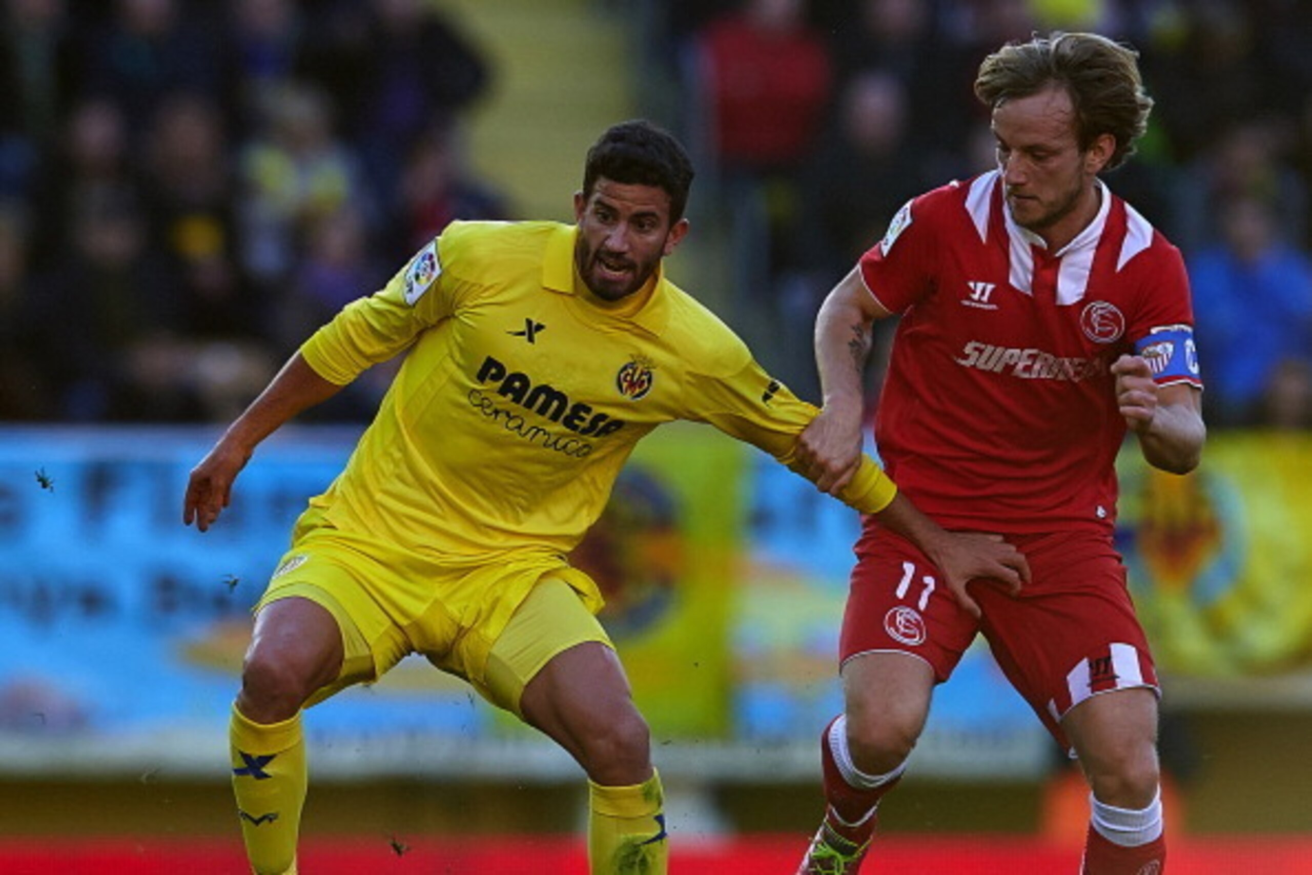 VILLARREAL, SPAIN - DECEMBER 21:  Mateo Musacchio (L) of Villarreal competes for the ball with Ivan Rakitic of Sevilla during the La Liga match between Villarreal CF and Sevilla FC at El Madrigal on December 21, 2013 in Villarreal, Spain.  (Photo by Manue