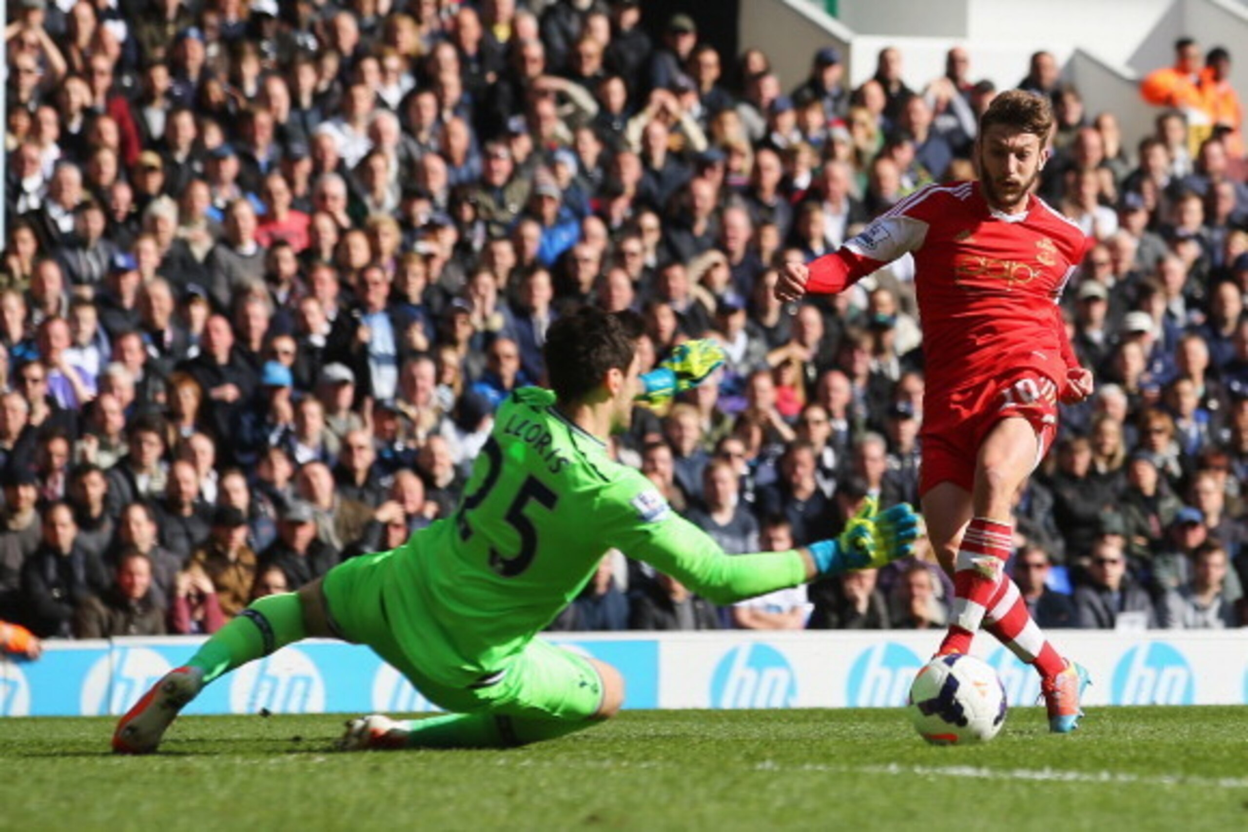 LONDON, ENGLAND - MARCH 23:  Adam Lallana of Southampton scores his team's second goal past Hugo Lloris of Tottenham Hotspur during the Barclays Premier League match between Tottenham Hotspur and Southampton at White Hart Lane on March 23, 2014 in London,