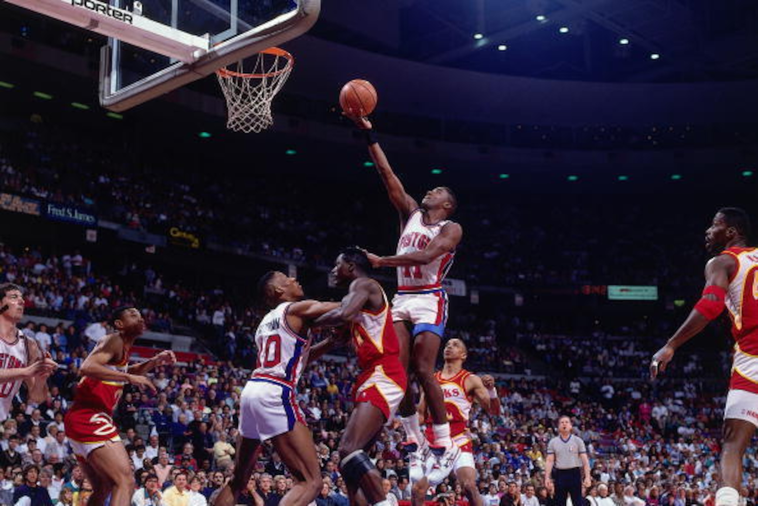 AUBURN HILLS, MI - 1990:  Isiah Thomas #11 of the Detroit Pistons shoots a layup against Dominique Wilkins #21 of the Atlanta Hawks during a game in 1990 at the Palace of Auburn Hills in Auburn Hills, Michigan.  NOTE TO USER: User expressly acknowledges t