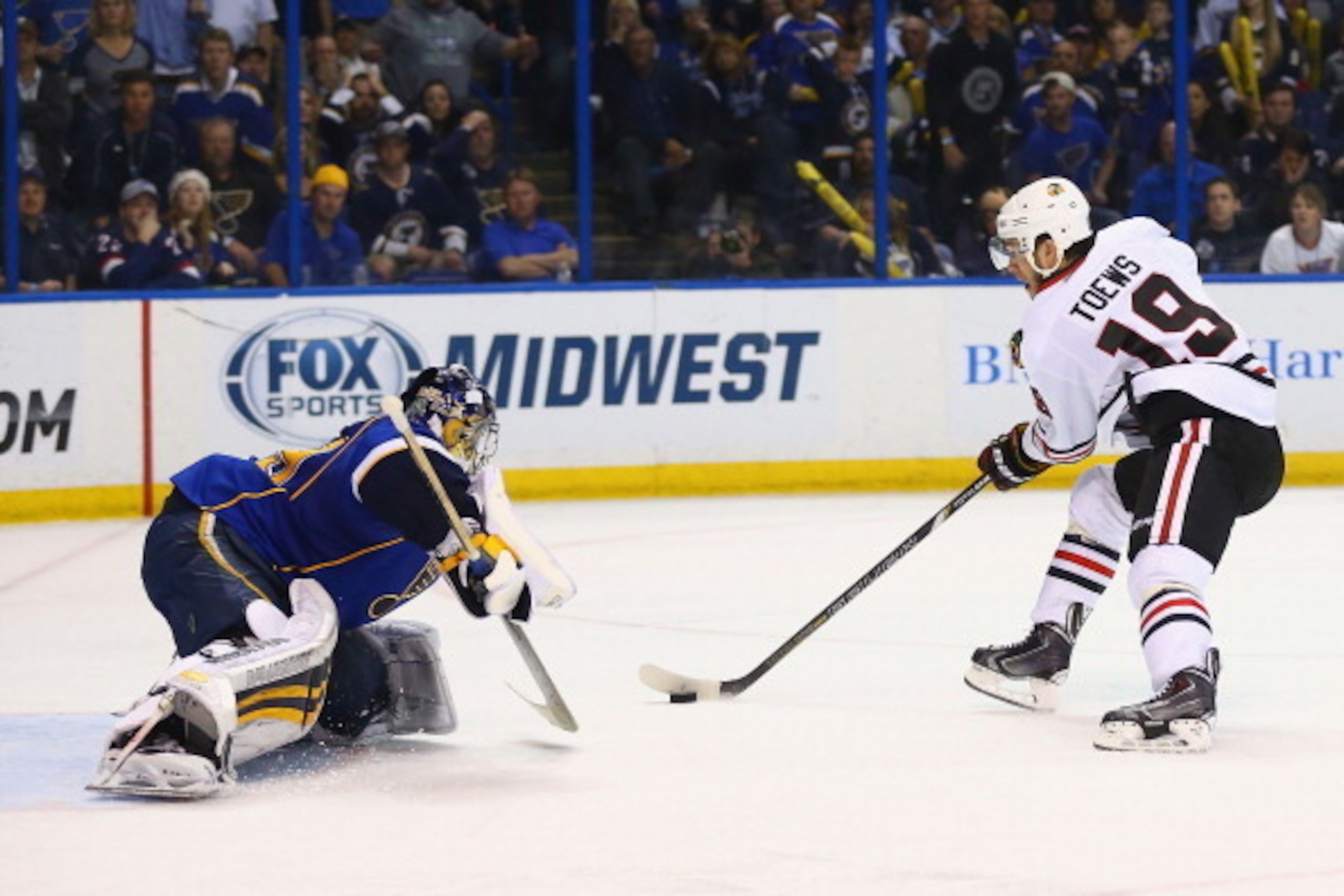 ST. LOUIS, MO - APRIL 25: Jonathan Toews #19 of the Chicago Blackhawks scores the game-winning goal against Ryan Miller #39 of the St. Louis Blues in Game Five of the First Round of the 2014 Stanley Cup Playoffs at the Scottrade Center on April 25, 2014 i ST. LOUIS, MO - APRIL 25: Jonathan Toews #19 of the Chicago Blackhawks scores the game-winning goal against Ryan Miller #39 of the St. Louis Blues in Game Five of the First Round of the 2014 Stanley Cup Playoffs at the Scottrade Center on April 25, 2014 i