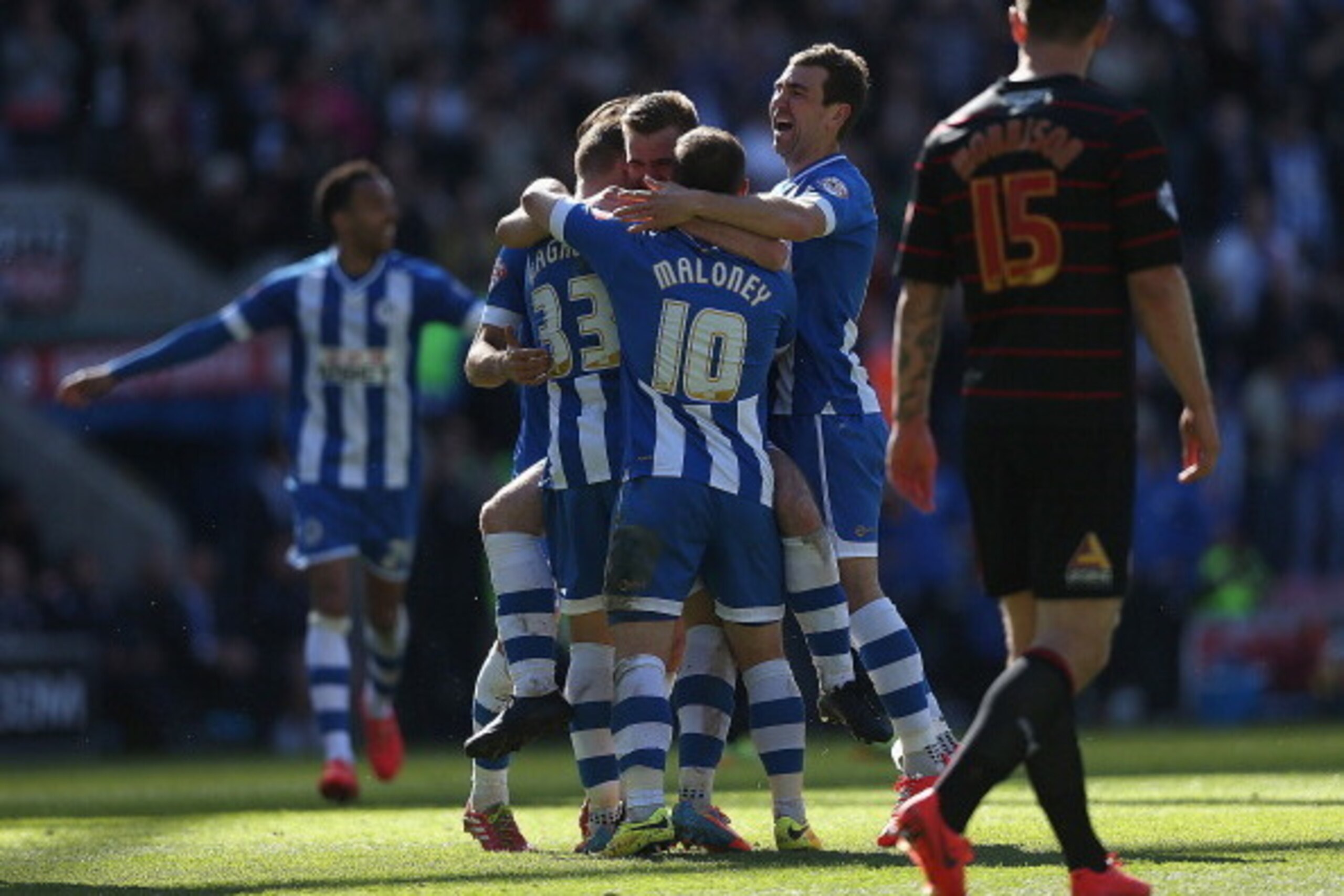 WIGAN, ENGLAND - APRIL 18:  James McArthur of Wigan celebrates team mate Callum McManaman of Wigan Athletic's third goal during the Sky Bet Championship match between Wigan Athletic and Reading at DW Stadium on April 18, 2014 in Wigan, England.  (Photo by