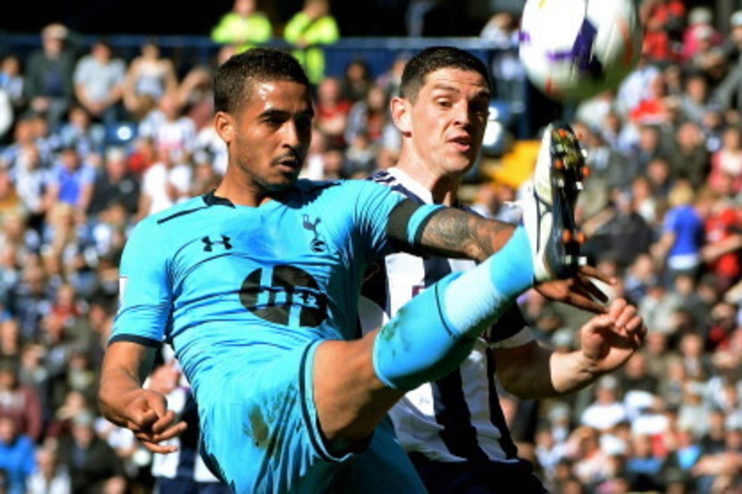WEST BROMWICH, ENGLAND - APRIL 12:  Kyle Naughton of Spurs clears the ball under pressure from Graham Dorrans of West Bromwich during the Barclays Premier League match between West Bromwich Albion and Tottenham Hotspur at The Hawthorns on April 12, 2014 i