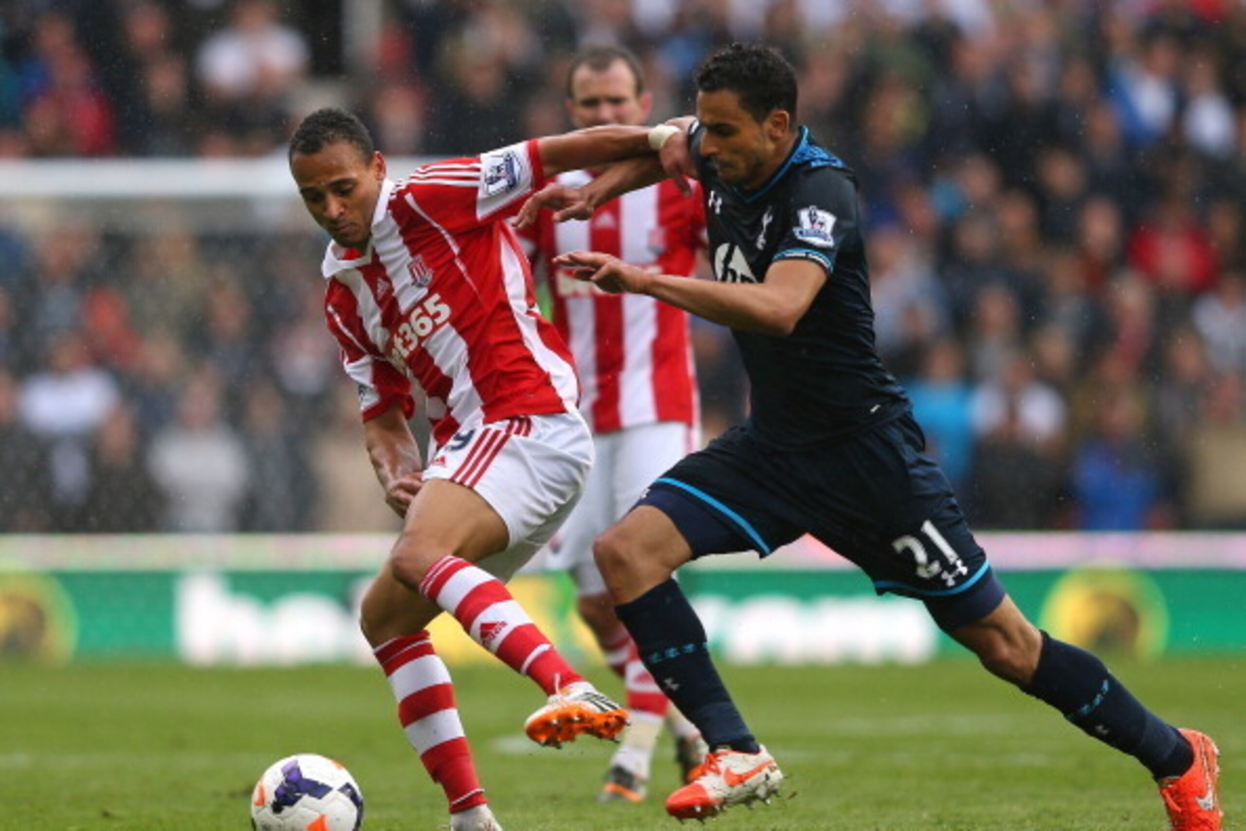 STOKE ON TRENT, ENGLAND - APRIL 26:  Peter Odemwingie of Stoke City is tackled by Nacer Chadli of Tottenham Hotspur during the Barclays Premier League match between Stoke City and Tottenham Hotspur at the Britannia Stadium on April 26, 2014 in Stoke on Tr