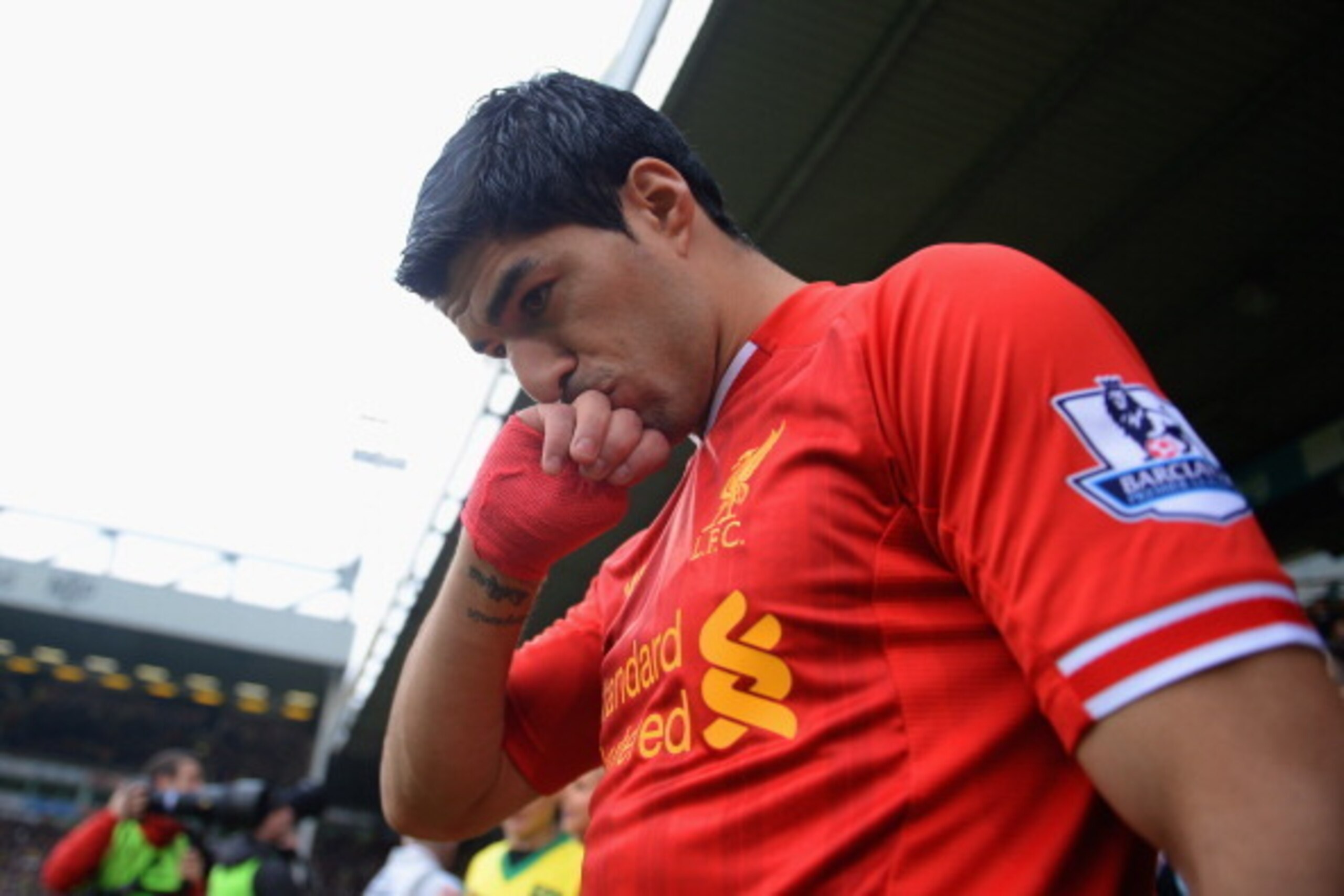 NORWICH, ENGLAND - APRIL 20:  Luis Suarez of Liverpool kisses his hand as he walks out during the Barclays Premier League match between Norwich City and Liverpool at Carrow Road on April 20, 2014 in Norwich, England.  (Photo by Michael Regan/Getty Images)