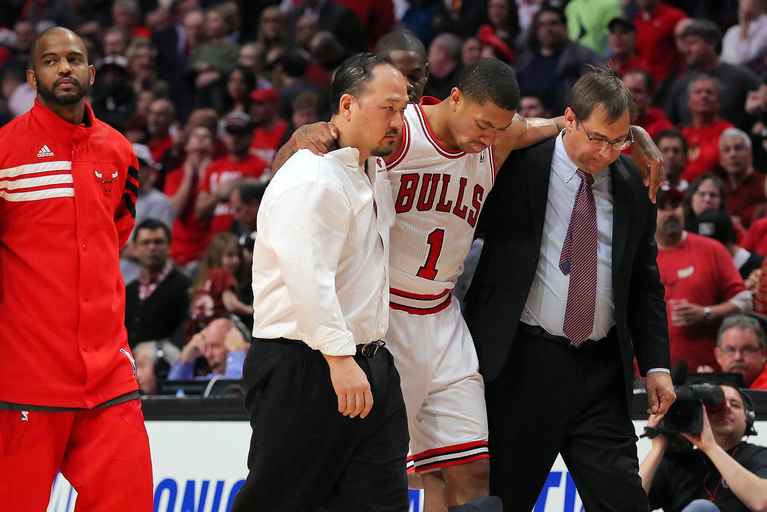 Apr 28, 2012; Chicago, IL, USA; Chicago Bulls injured point guard Derrick Rose (1) is helped off the court by medical staff during the fourth quarter in the Eastern Conference quarterfinals of the 2012 NBA Playoffs against the Philadelphia 76ers at the Un