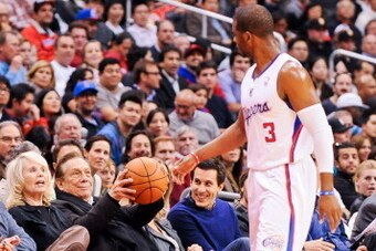 LOS ANGELES, CA - FEBRUARY 13: Chris Paul #3 of the Los Angeles Clippers tosses a basketball to team owner Donald Sterling during a game against the Houston Rockets at Staples Center on February 13, 2013 in Los Angeles, California. NOTE TO USER: User expr