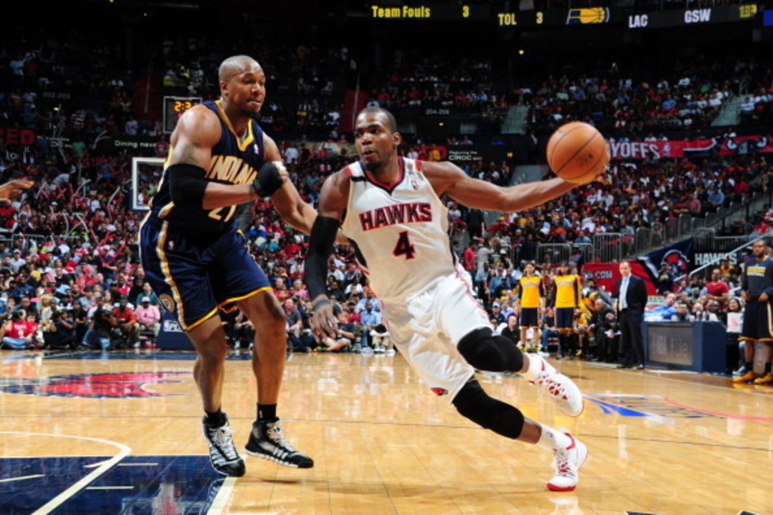 ATLANTA, GA - APRIL 24:  Paul Millsap #4 of the Atlanta Hawks handles the ball against David West #21 of the Indiana Pacers during Game Three of the Eastern Conference Quarterfinals on April 24, 2014 at Philips Arena in Atlanta, Georgia.  NOTE TO USER: Us