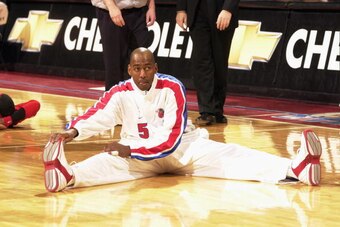 AUBURN HILLS, MI - FEBRUARY 5:  Danny Manning #5 of the Detroit Pistons does stretch exercises during warm-ups prior to the NBA game against the Los Angeles Clippers at The Palace of Auburn Hills on February 5, 2003 in Auburn Hills, Michigan.  The Pistons