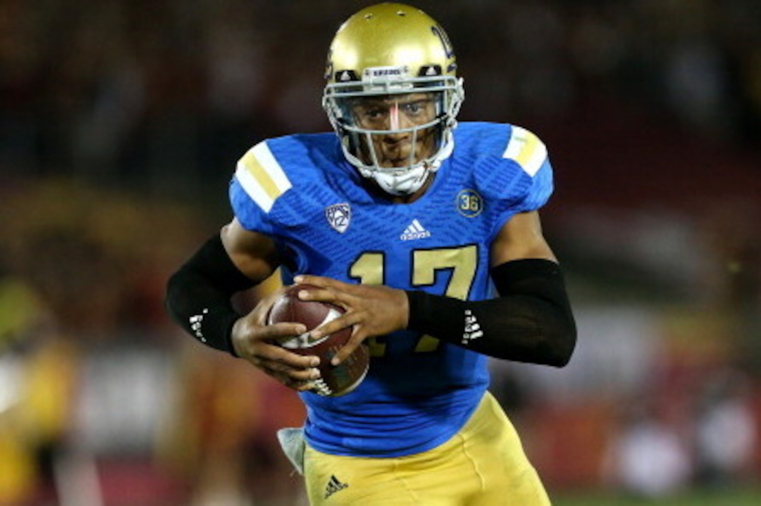 LOS ANGELES, CA - NOVEMBER 30:  Quarterback Brett Hundley #17 of the UCLA Bruins carries on a 12 yard touchdown run in the third quarter against the USC Trojans at Los Angeles Coliseum on November 30, 2013 in Los Angeles, California.  The Bruins won 35-14