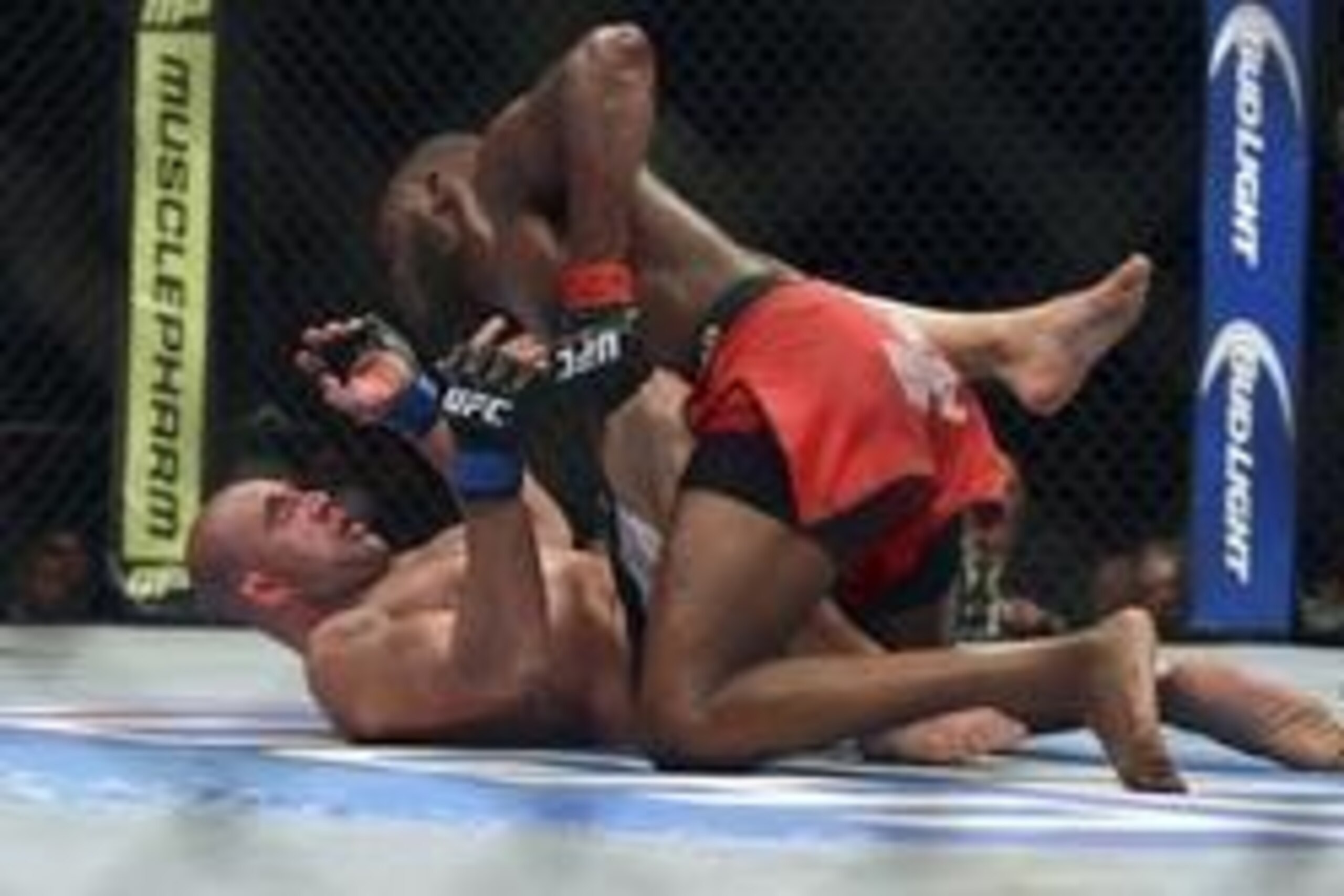 Apr 26, 2014; Baltimore, MD, USA;  Jon Jones (top) punches Glover Teixeira during the UFC light heavy weight championship fight at  Baltimore Arena. Jones retained the light heavy height championship by defeating  Teixeria.  Mandatory Credit: Tommy Gillig