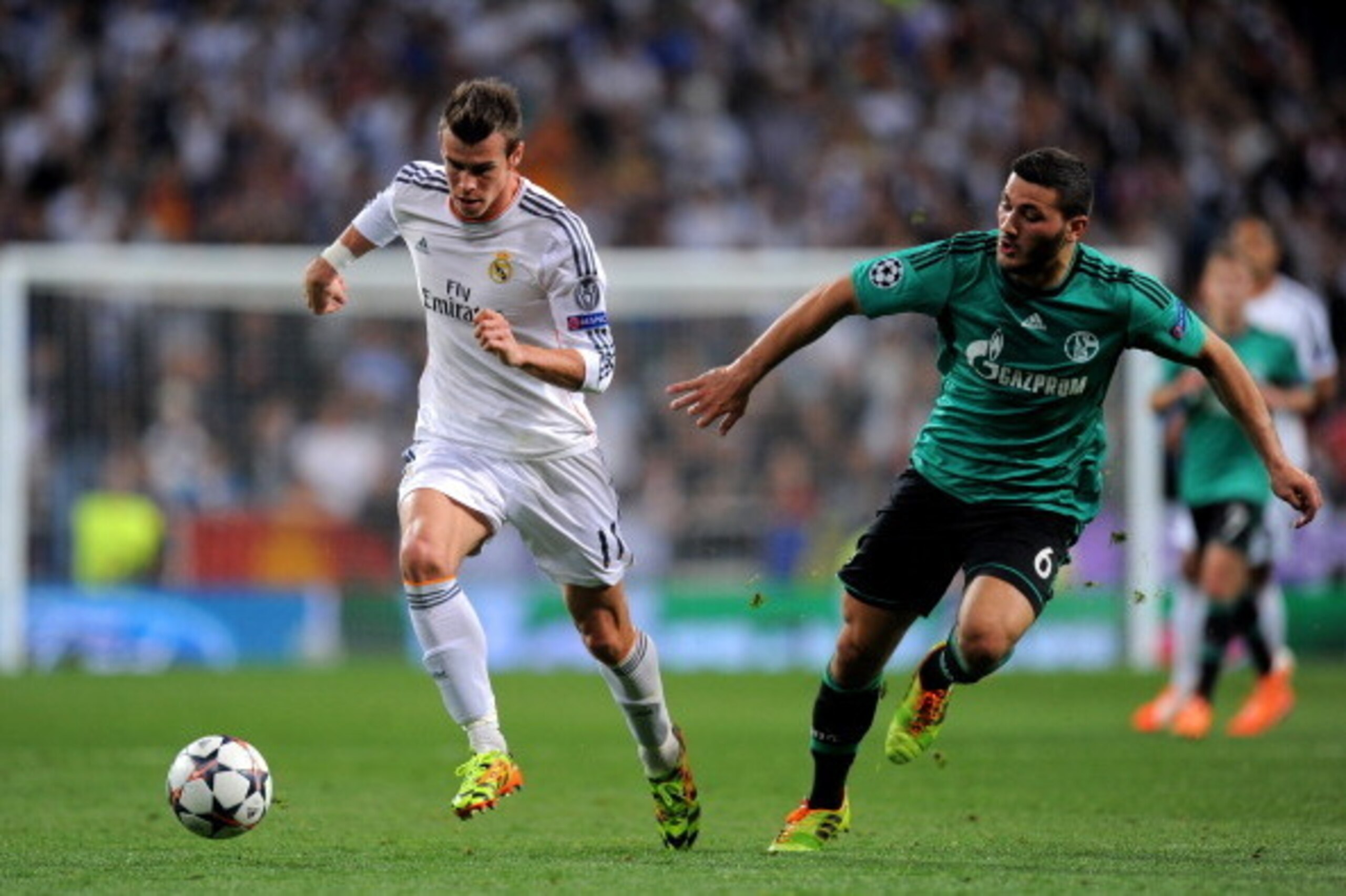 MADRID, SPAIN - MARCH 18:  Gareth Bale of Real Madrid is pursued by Sead Kolasinac of Schalke during the UEFA Champions League Round of 16, second leg match between Real Madrid and FC Schalke 04 at Estadio Santiago Bernabeu on March 18, 2014 in Madrid, Sp