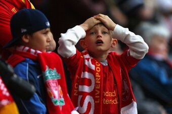 LIVERPOOL, ENGLAND - APRIL 27:  Ayoung Liverpool fan reacts during the Barclays Premier League match between Liverpool and Chelsea at Anfield on April 27, 2014 in Liverpool, England.  (Photo by Clive Brunskill/Getty Images)