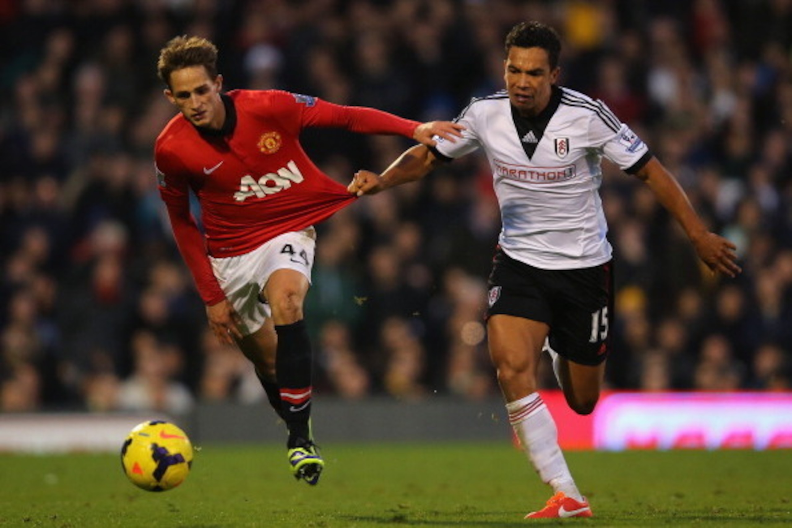 LONDON, ENGLAND - NOVEMBER 02: Kieran Richardson of Fulham pulls on the shirt of Adnan Januzaj of Manchester United  during the Barclays Premier League match between Fulham and Manchester United at Craven Cottage on November 2, 2013 in London, England.  (