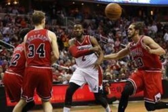 Apr 27, 2014; Washington, DC, USA; Washington Wizards guard John Wall (2) passes the ball as Chicago Bulls forward Mike Dunleavy (34) and Bulls center Joakim Noah (13) defend in the second quarter in game four of the first round of the 2014 NBA Playoffs a