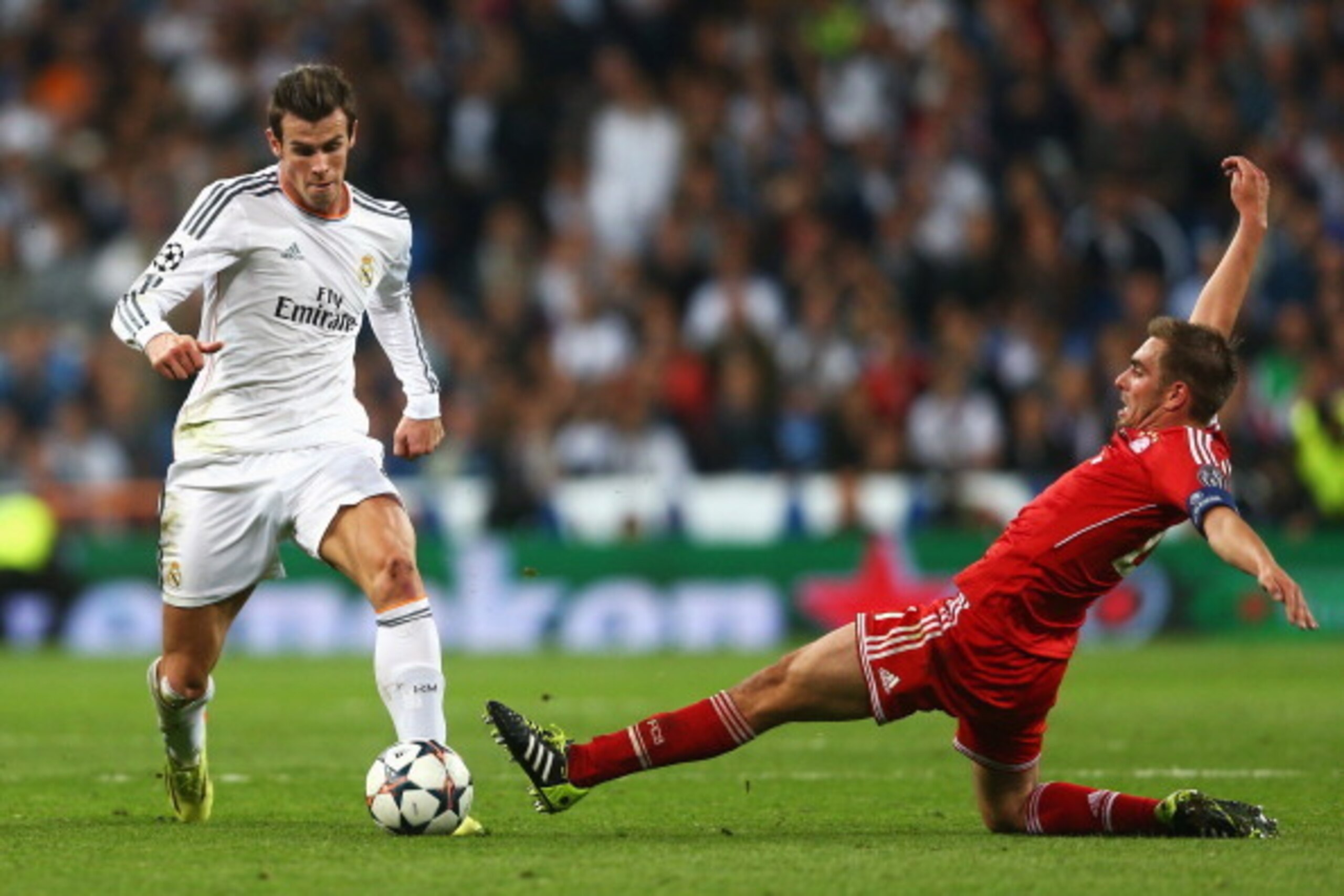 MADRID, SPAIN - APRIL 23: Gareth Bale of Real Madrid takes on Philipp Lahm of Bayern Muenchen during the UEFA Champions League semi-final first leg match between Real Madrid and FC Bayern Muenchen at the Estadio Santiago Bernabeu on April 23, 2014 in Madr